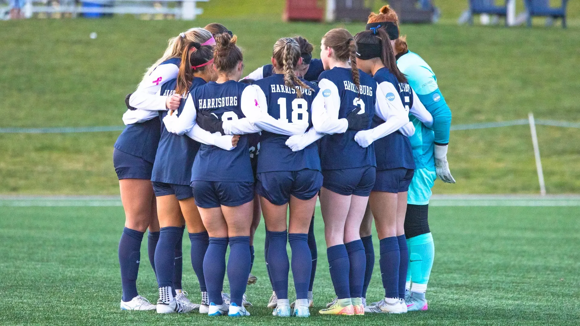 women's soccer players huddle up during an ncaa tournament sweet sixteen game against mary washington in 2025
