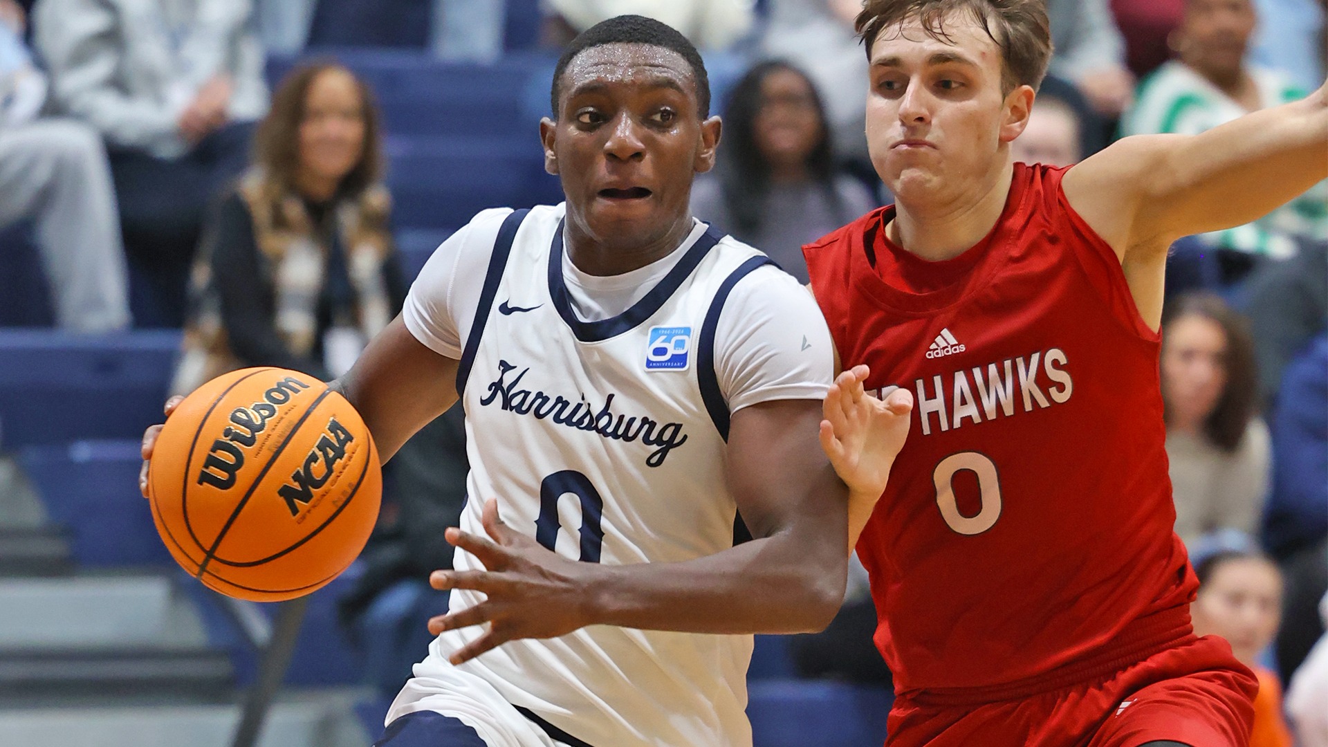 andre thomas drives past a defender during a game against montclair state in 2025