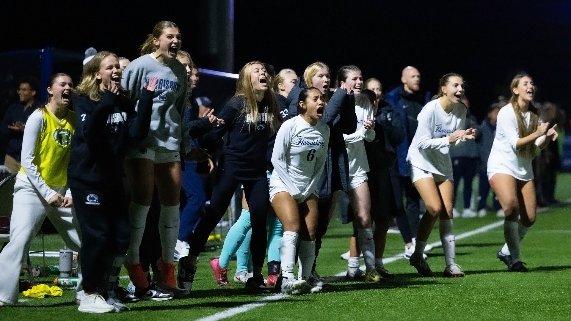 women's soccer players and coaches celebrate on the sideline during the united east championship game in 2025