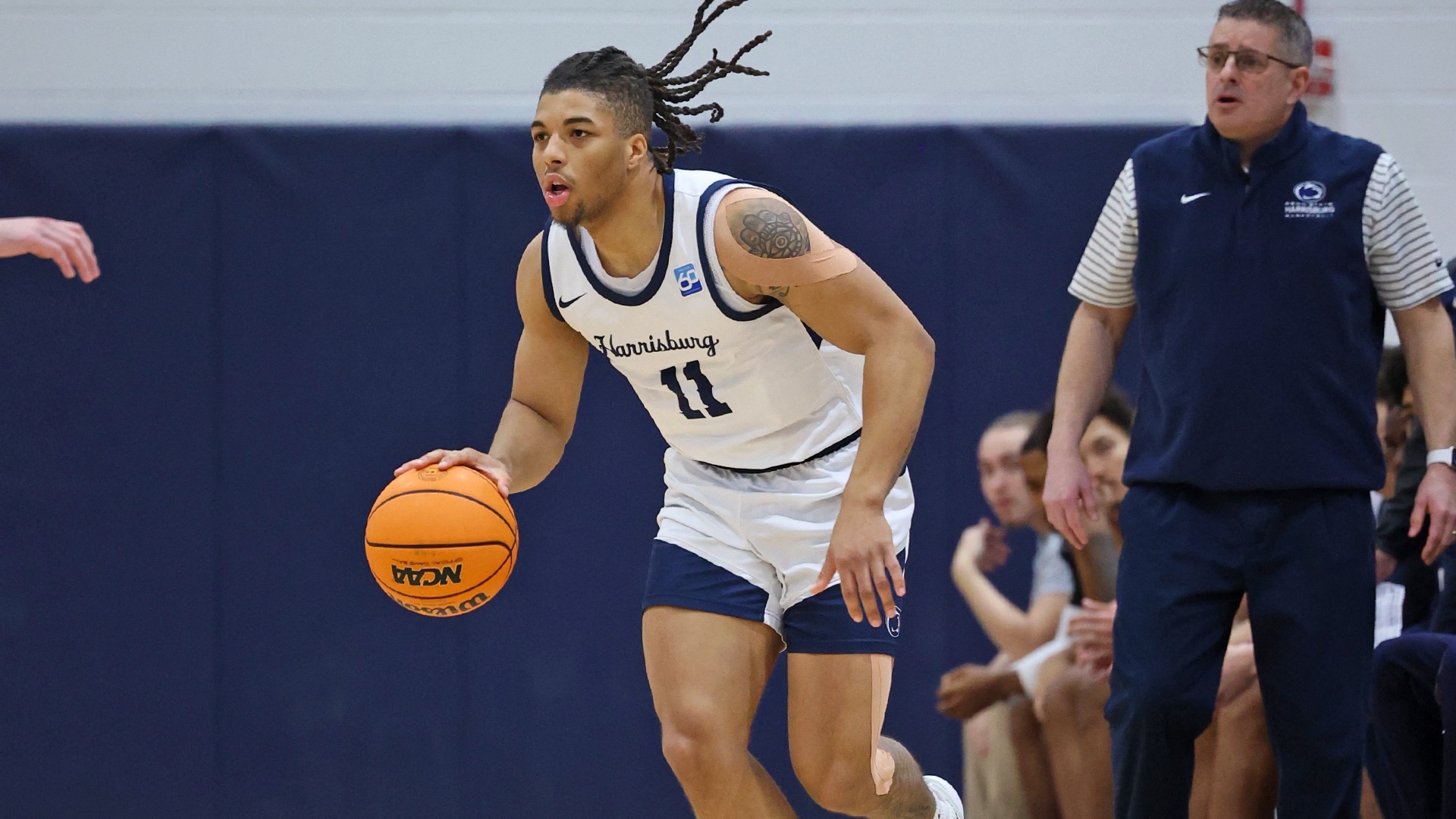 chris henderson dribbles near the penn state harrisburg bench during a win over muhlenberg in 2025