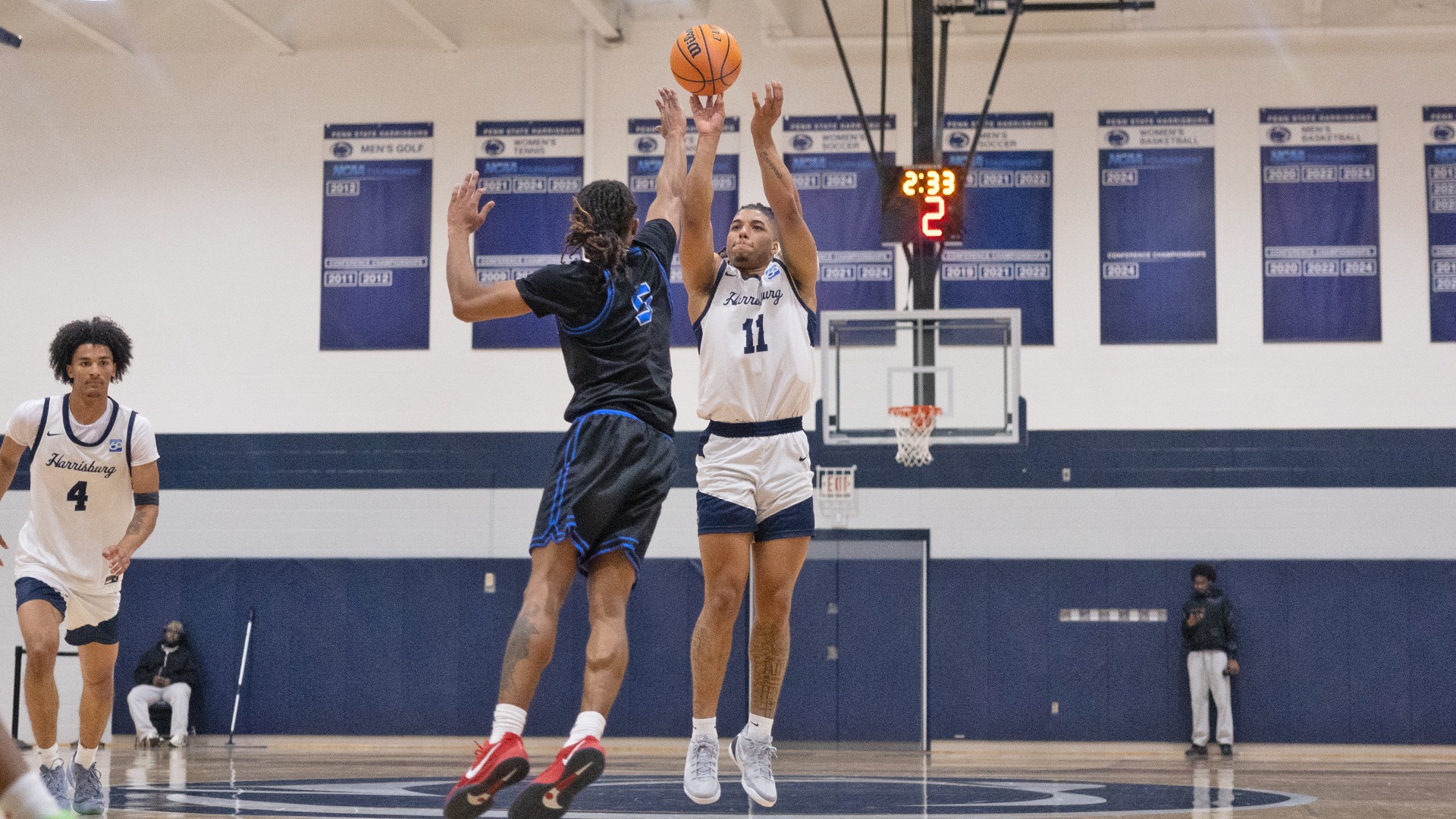 chris henderson shoots a three-pointer in a win over wilson at the capital union building