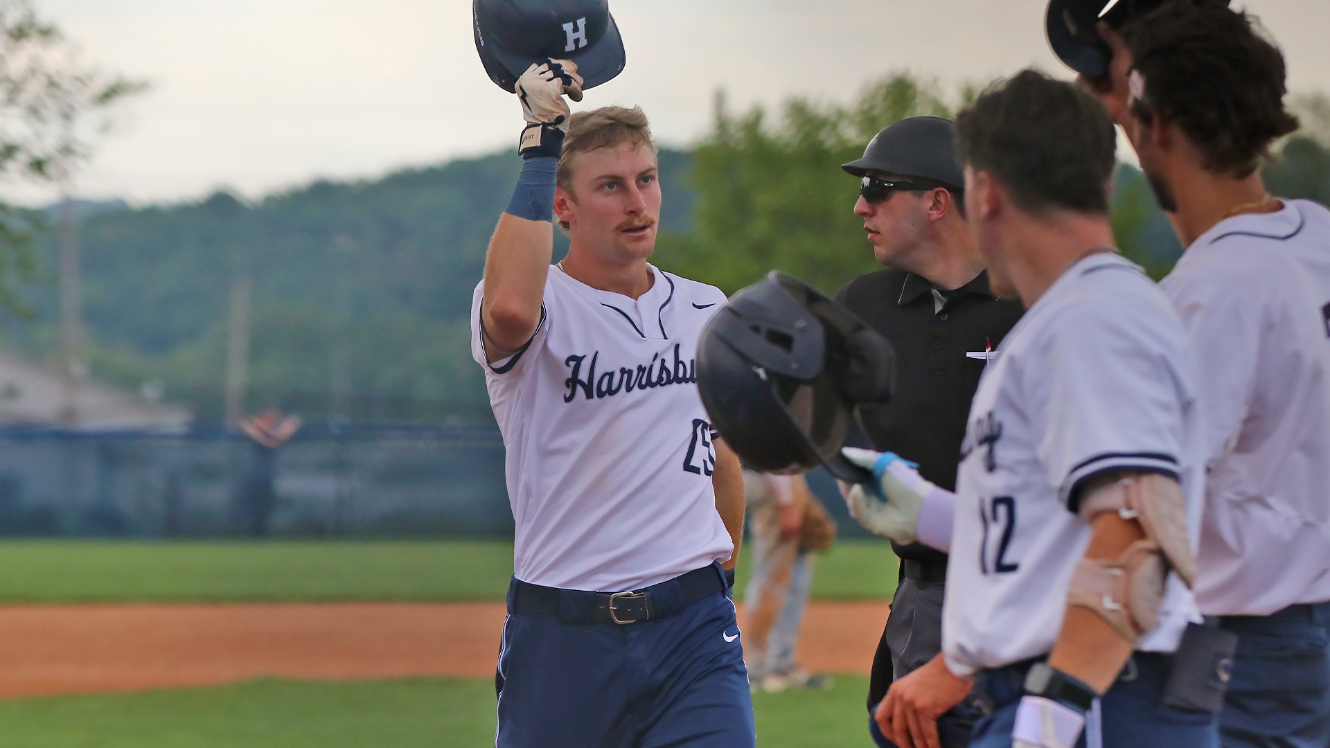 blaine waltimyer celebrates with teammates at home plate after hitting a home run during a win over penn state berks in 2025