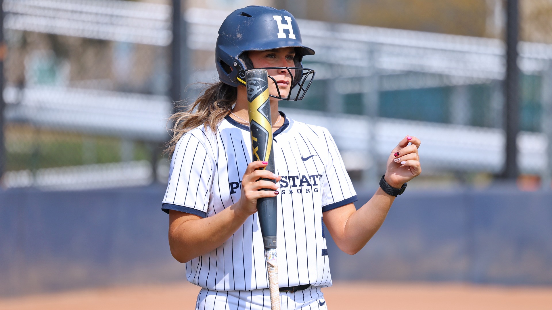 maddy lehigh looks into the field at a teammate on base while on deck during a game in 2025