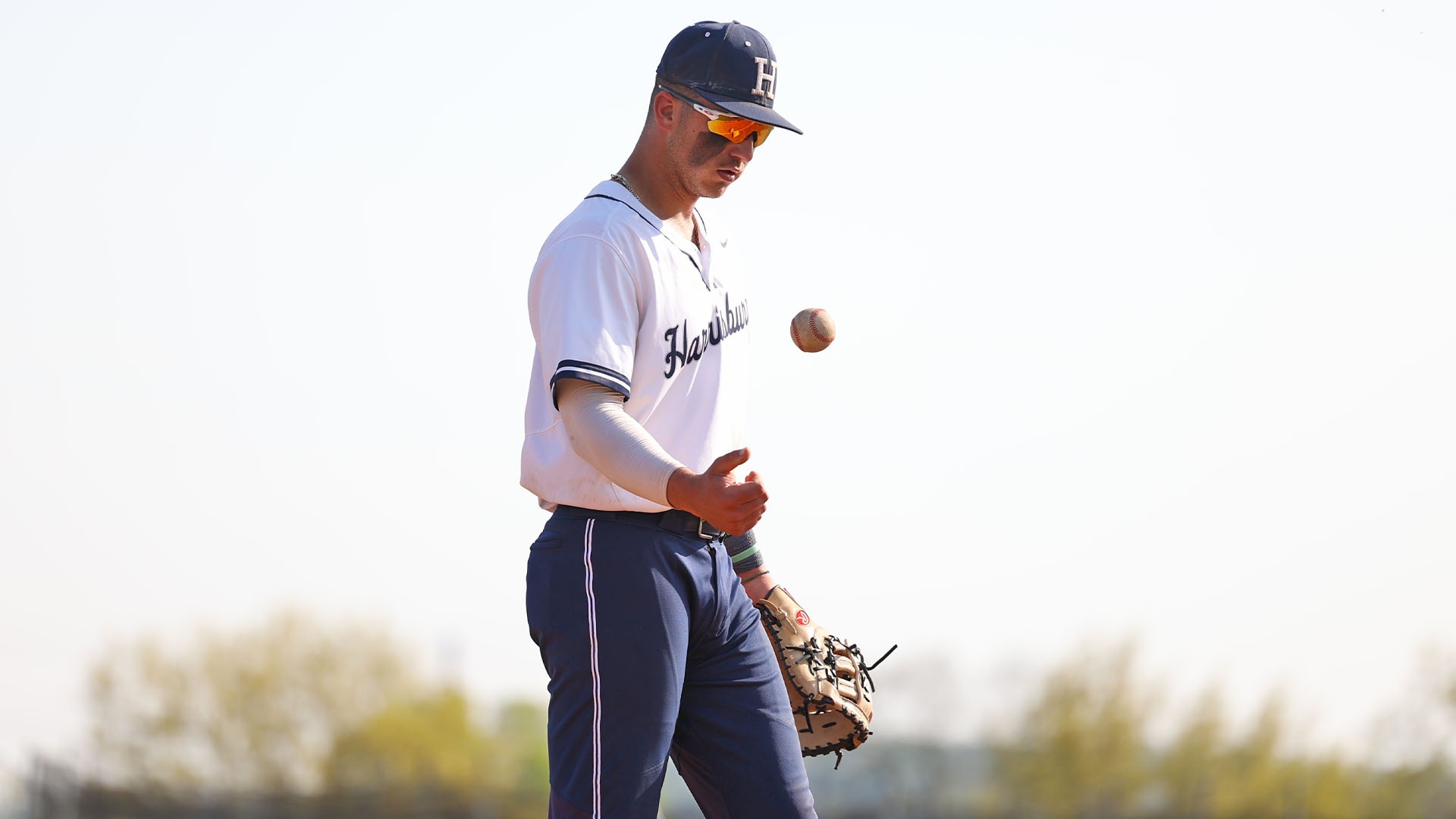 demetre koutras flips a baseball to himself during a win over scranton in 2025