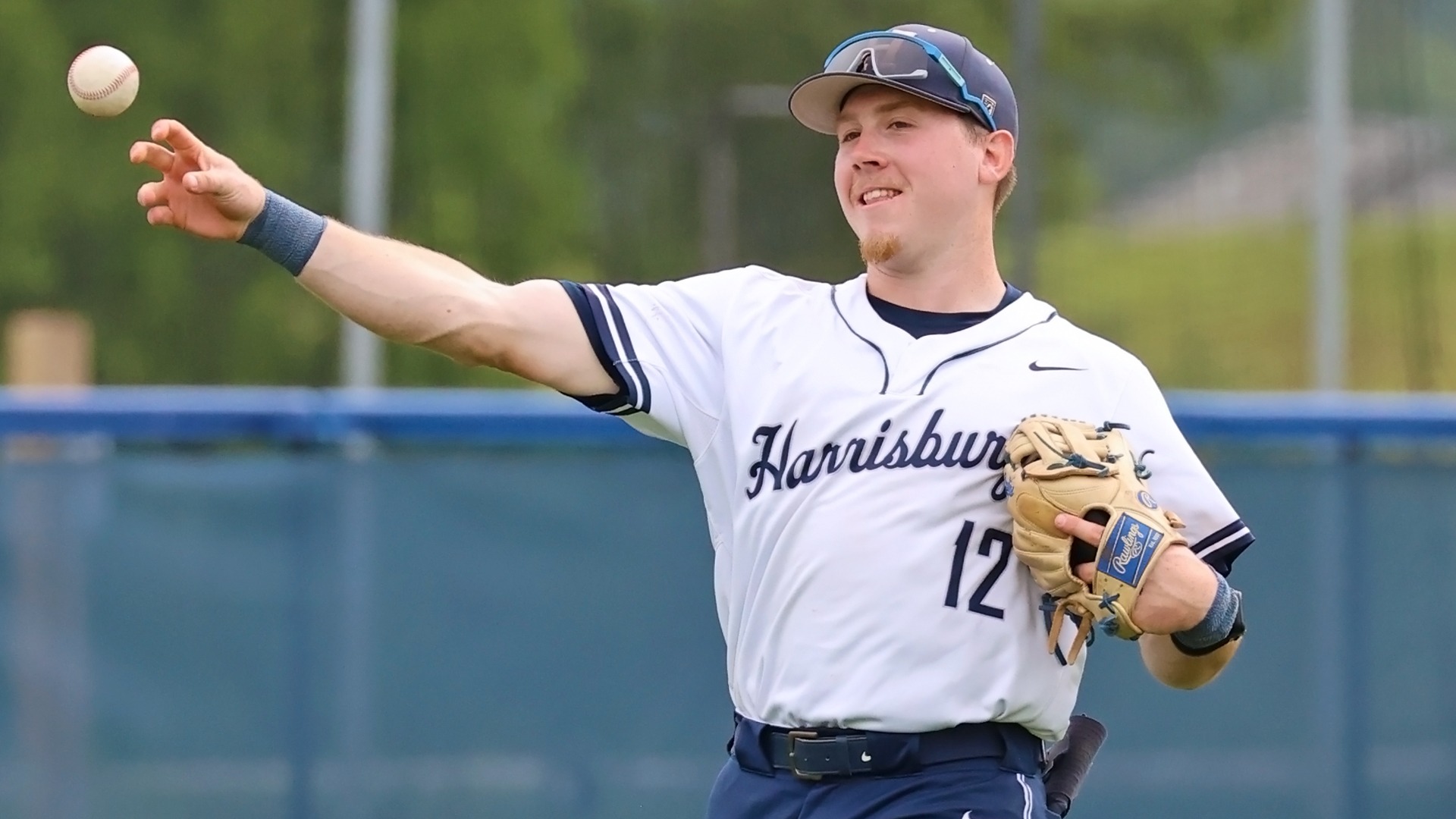 brendan henn smiles while he throws a ball in the outfield during an ncaa tournament win over tcnj in 2025 