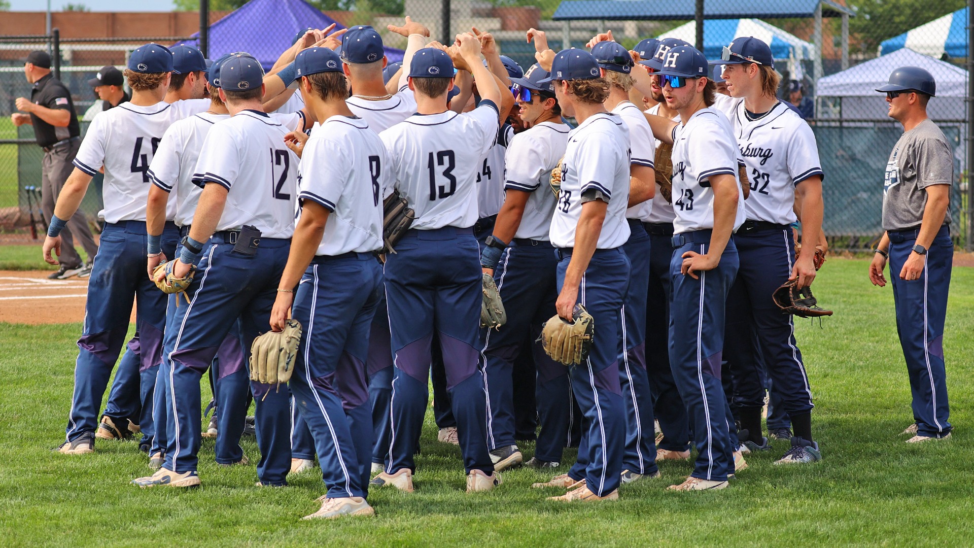 baseball players huddle up near home plate before an ncaa tournament win over tcnj in 2025