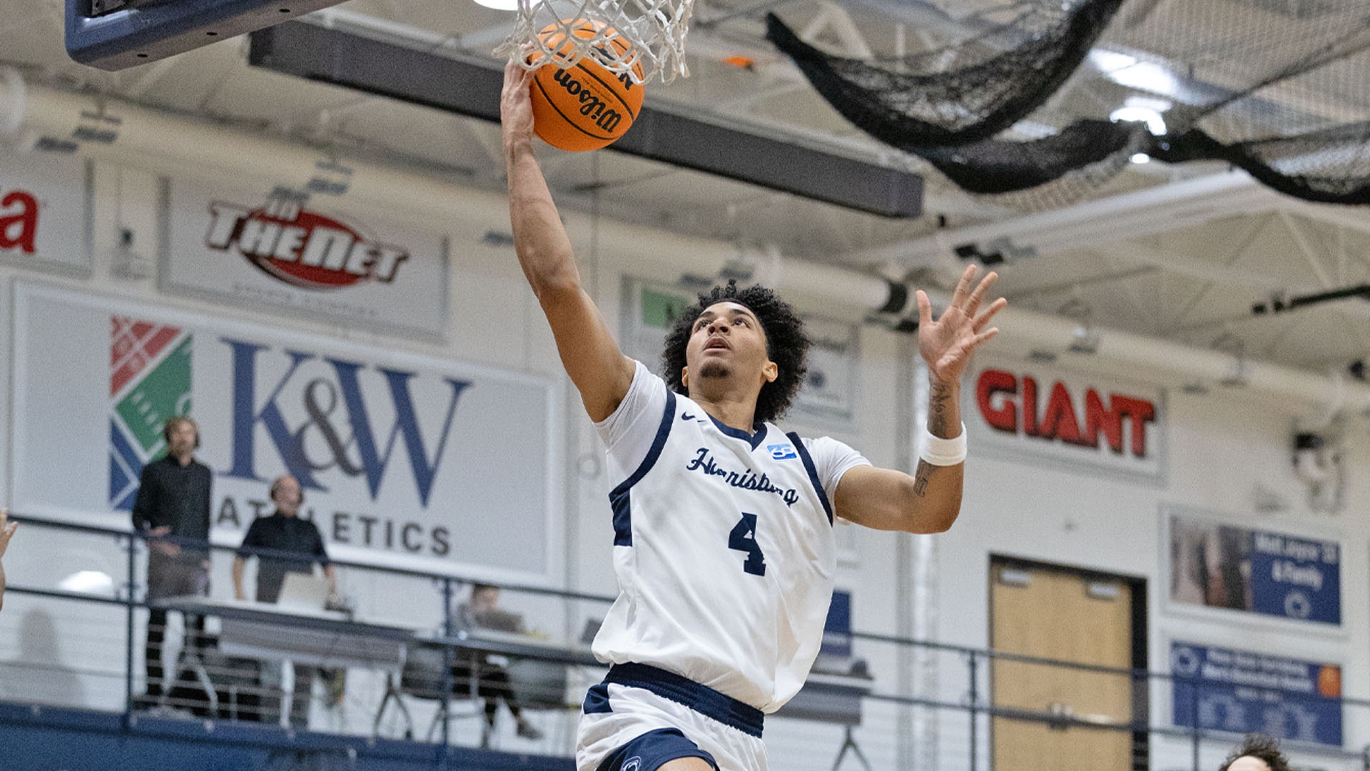 dylan moore lays the ball up at the hoop in a win over gallaudet