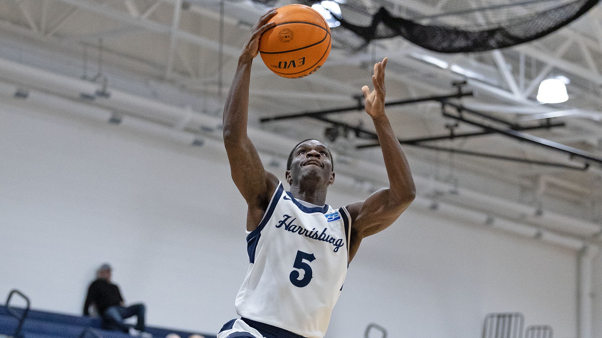 isaiah millien drives to the hoop in a win over penn state berks