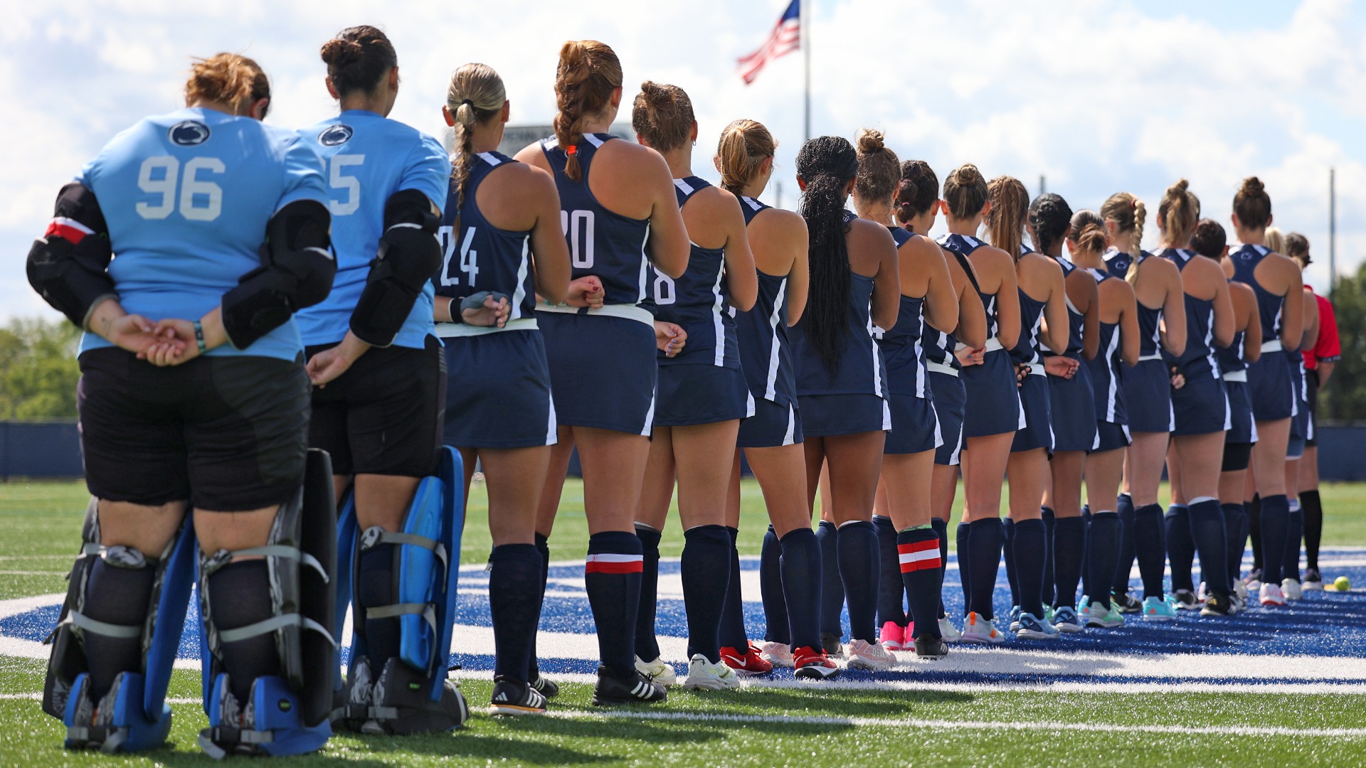 field hockey players line up at midfield during the national anthem before a game against albright in 2025