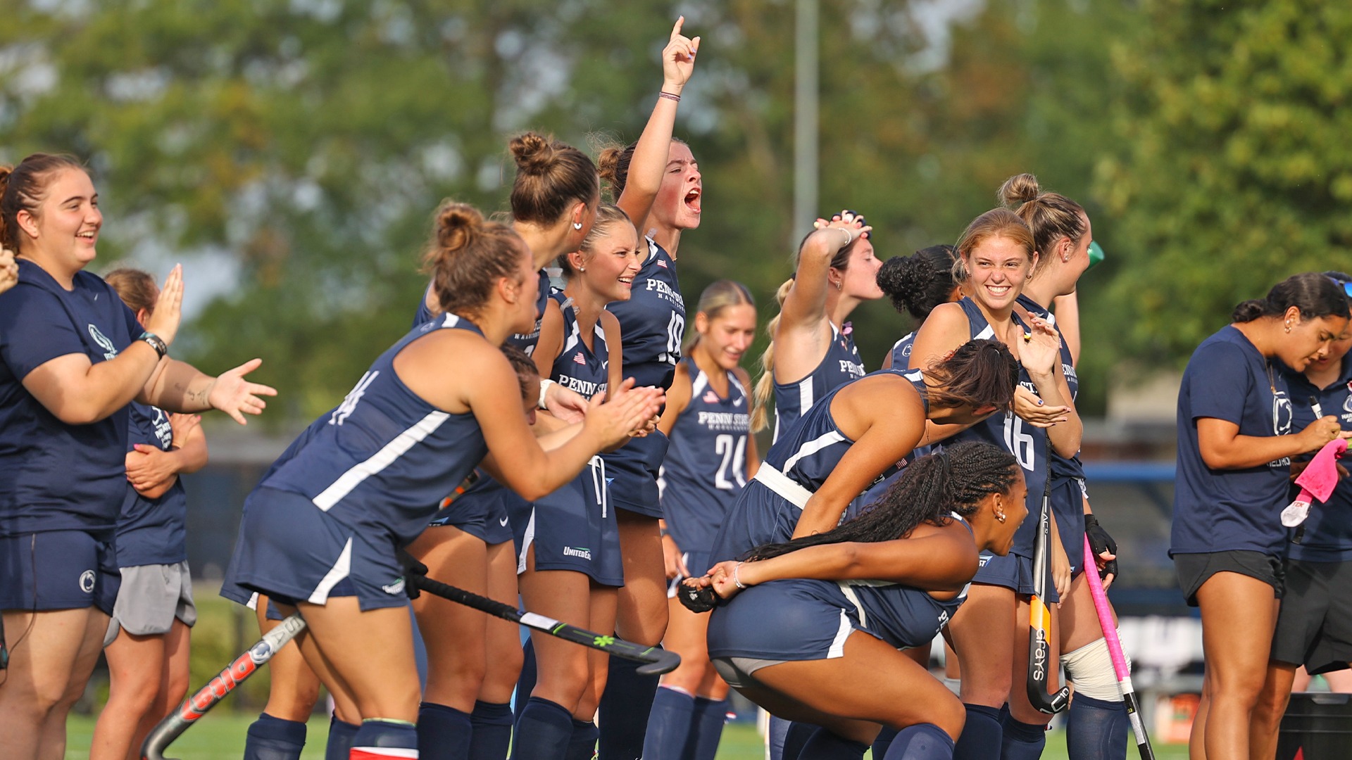 field hockey players celebrate near midfield during penalty strokes in a win over LVC in 2025