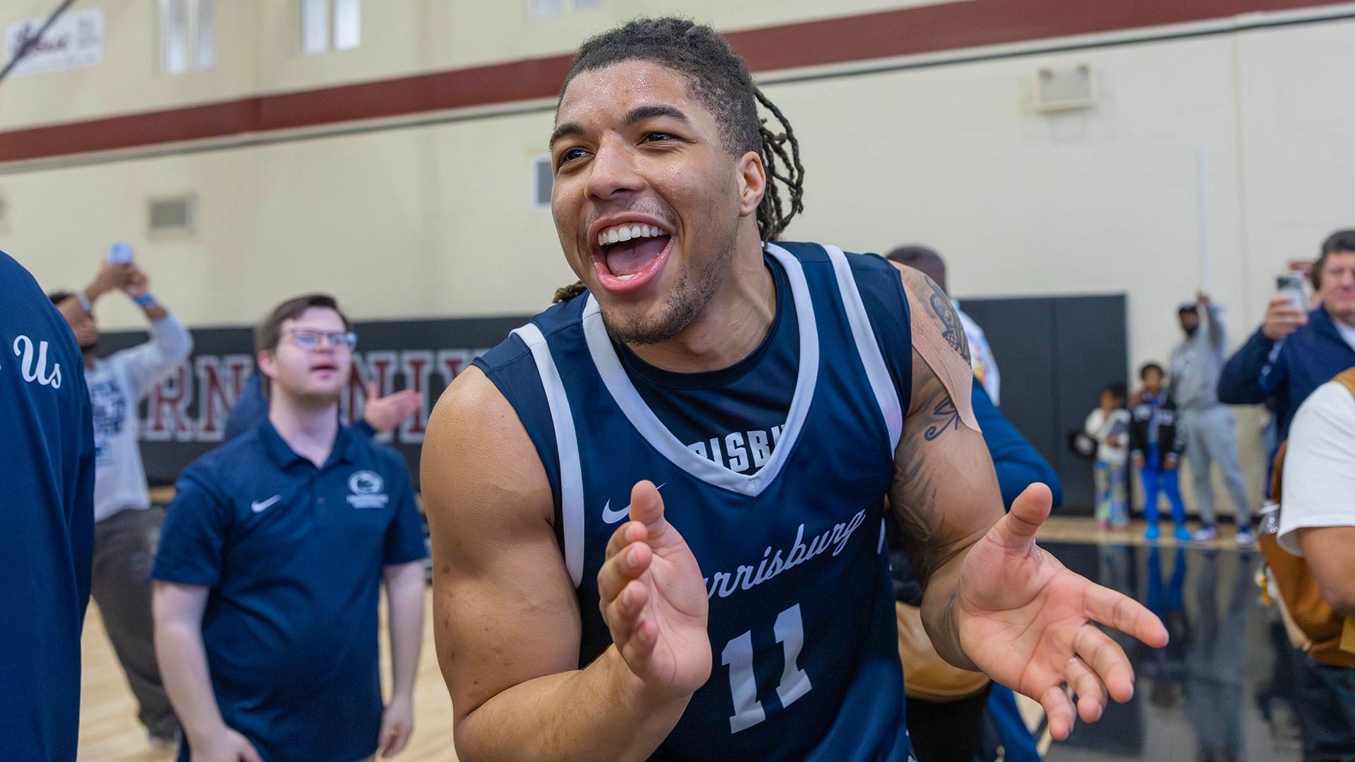 chris henderson celebrates after men's basketball wins the 2026 united east championships