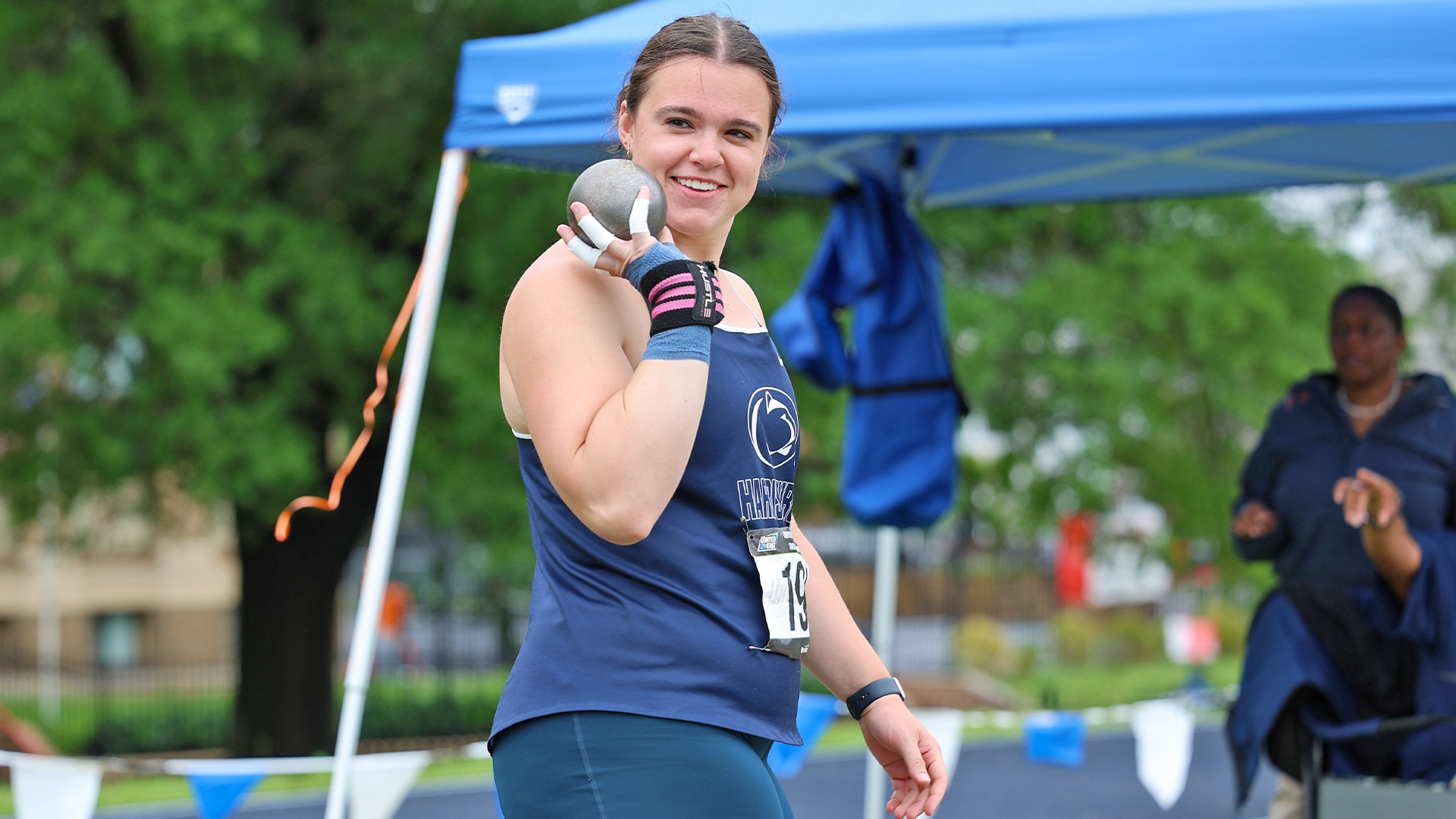 isabella mcguire smiles before competing in the shot put at the united east championships in 2025