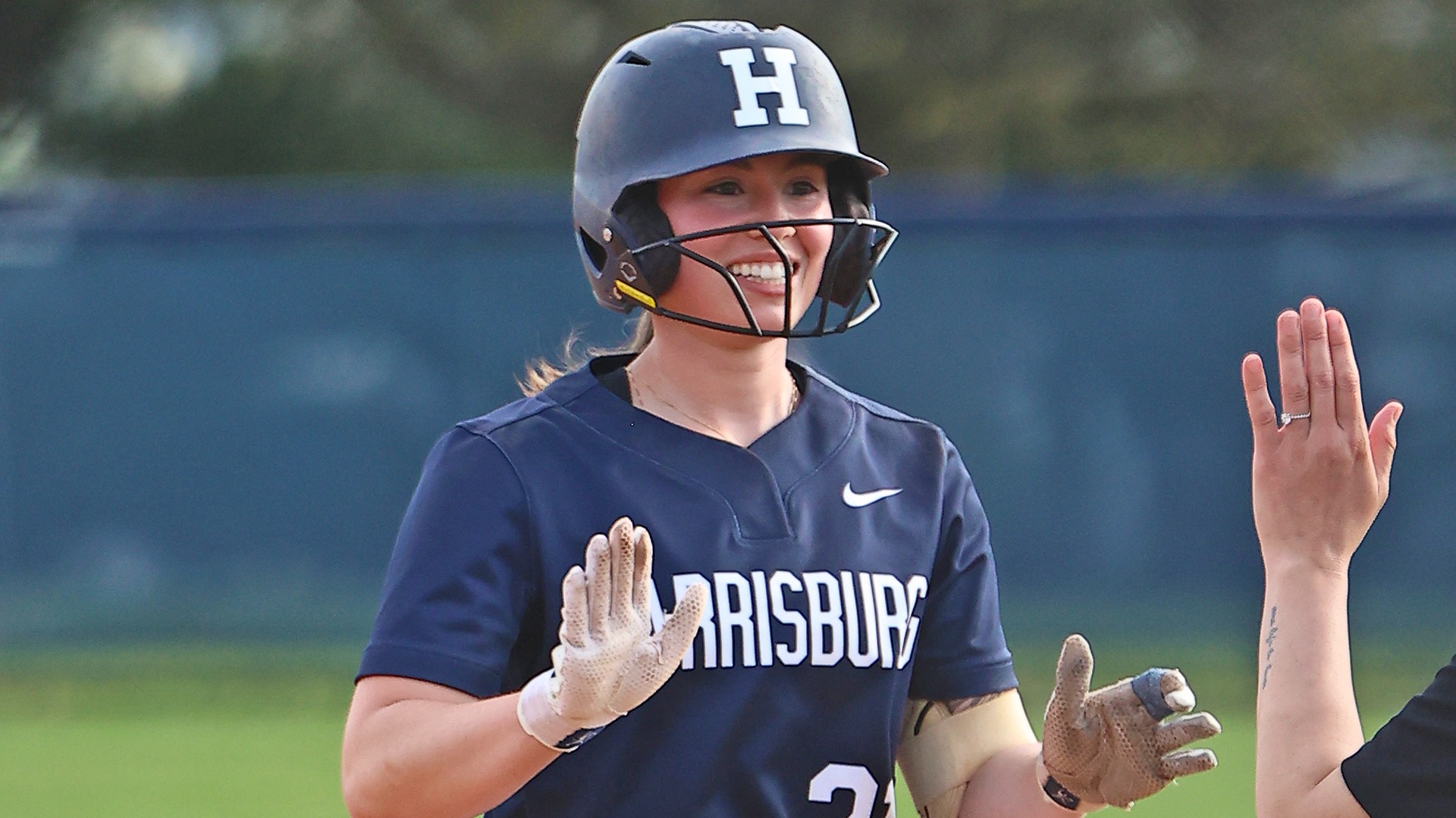 lily feltenberger smiles at first base after singling during a win over valley forge in 2025