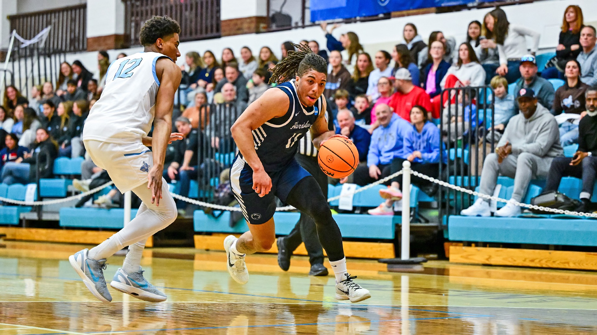 chris henderson drives past a tufts defender during an ncaa tournament game in 2026