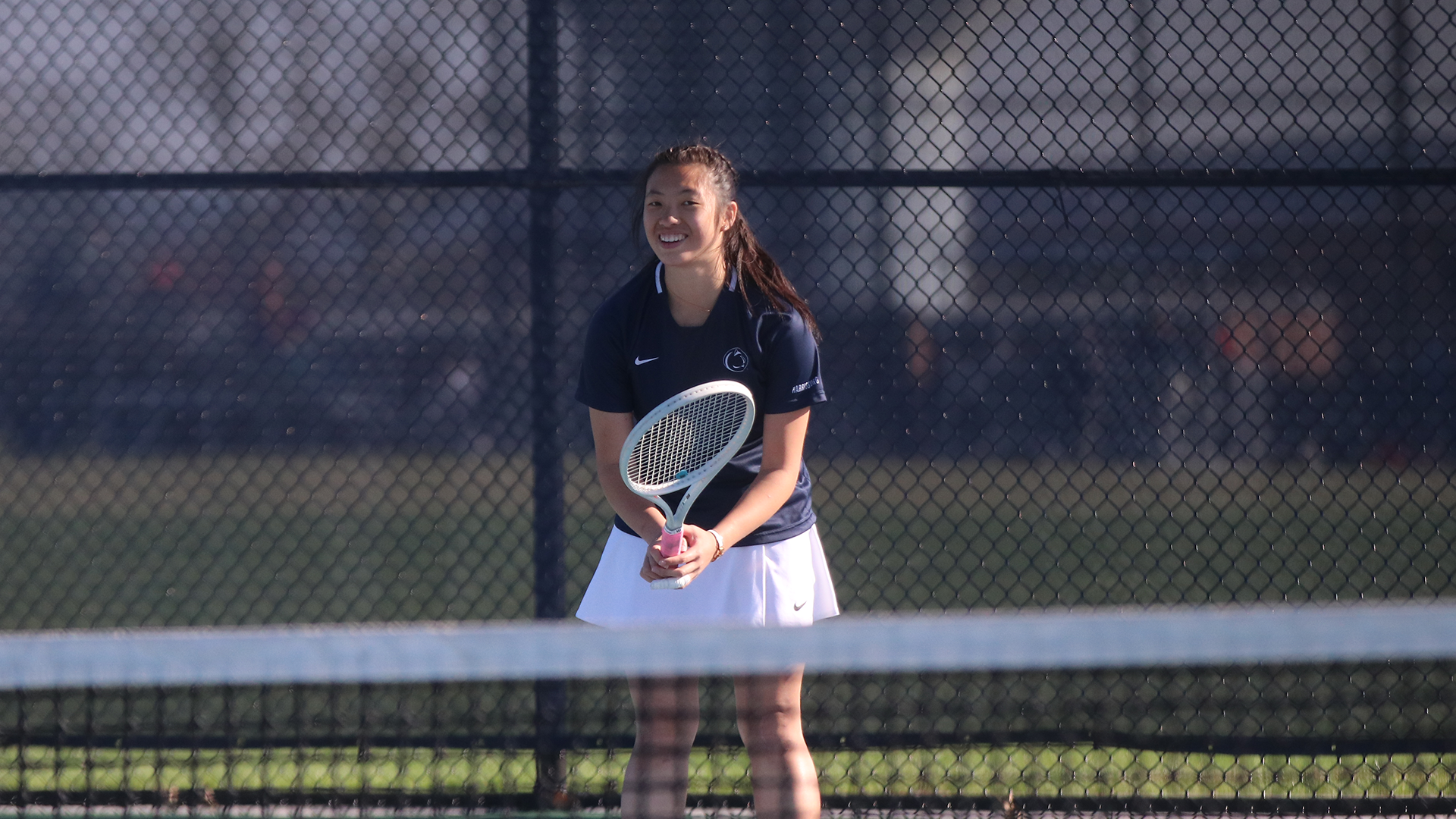 Ko smiles as she waits to return a serve