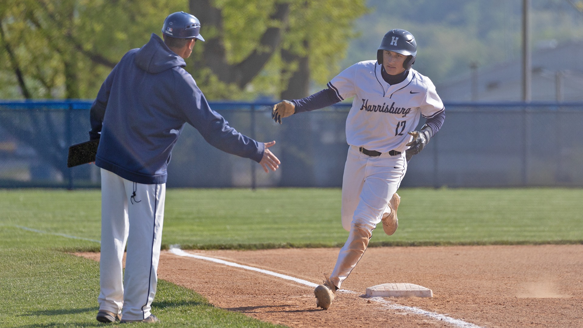 james quici rounds third base and gives coach bown a high five after hitting a home run against penn state brandywine
