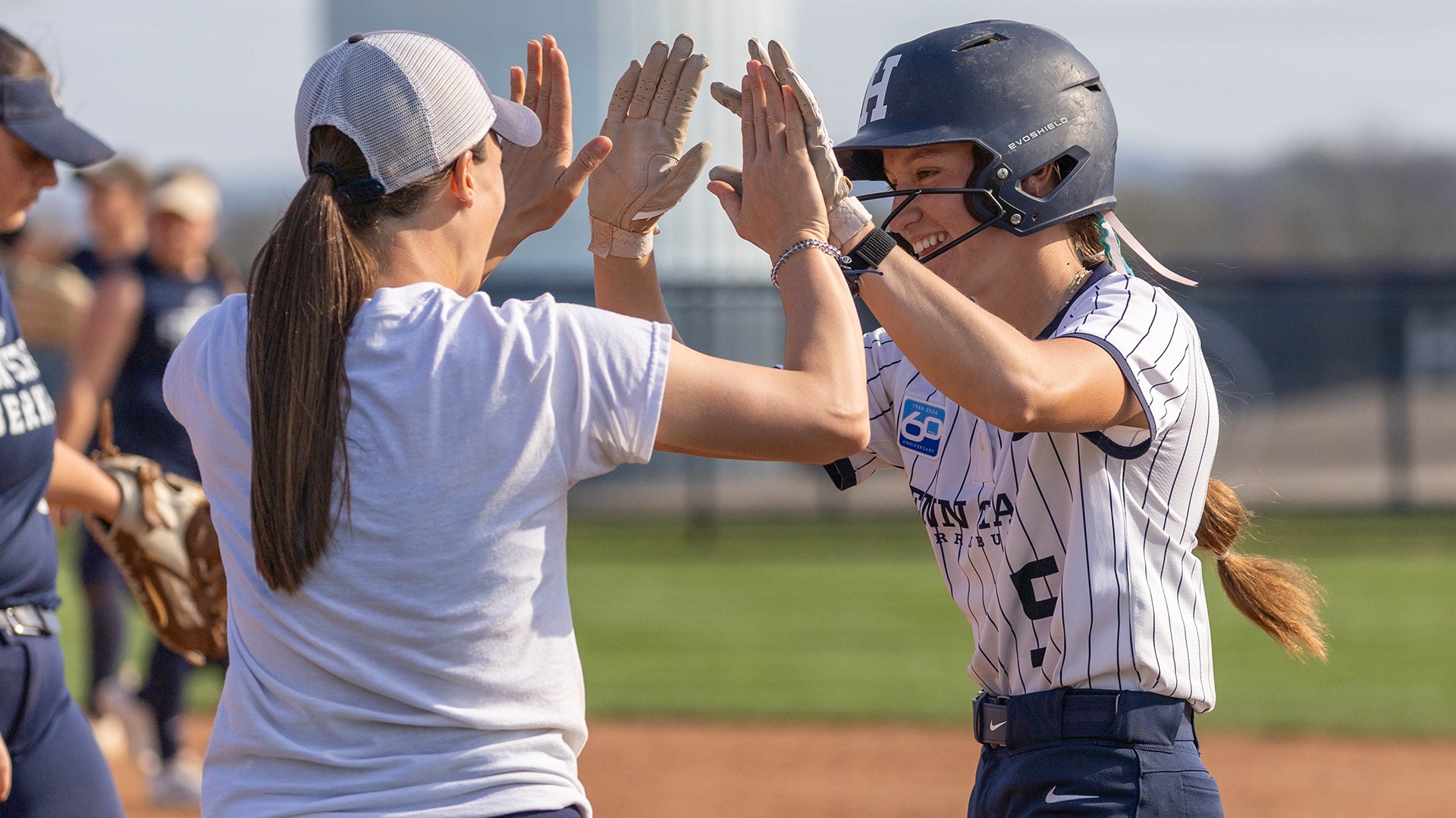 lauren maguire high fives assistant softball coach erika keen in a game against gwynedd mercy