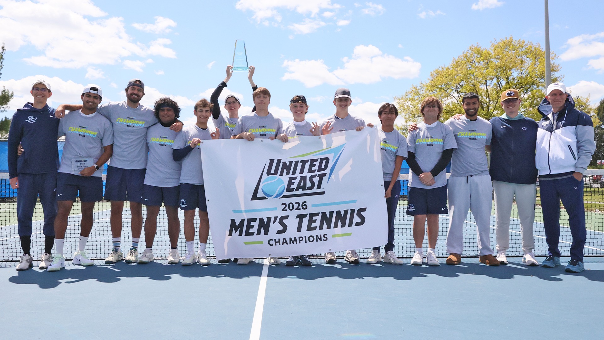 the 2025-26 men's tennis team poses after winning the united east championship over st mary's college of maryland