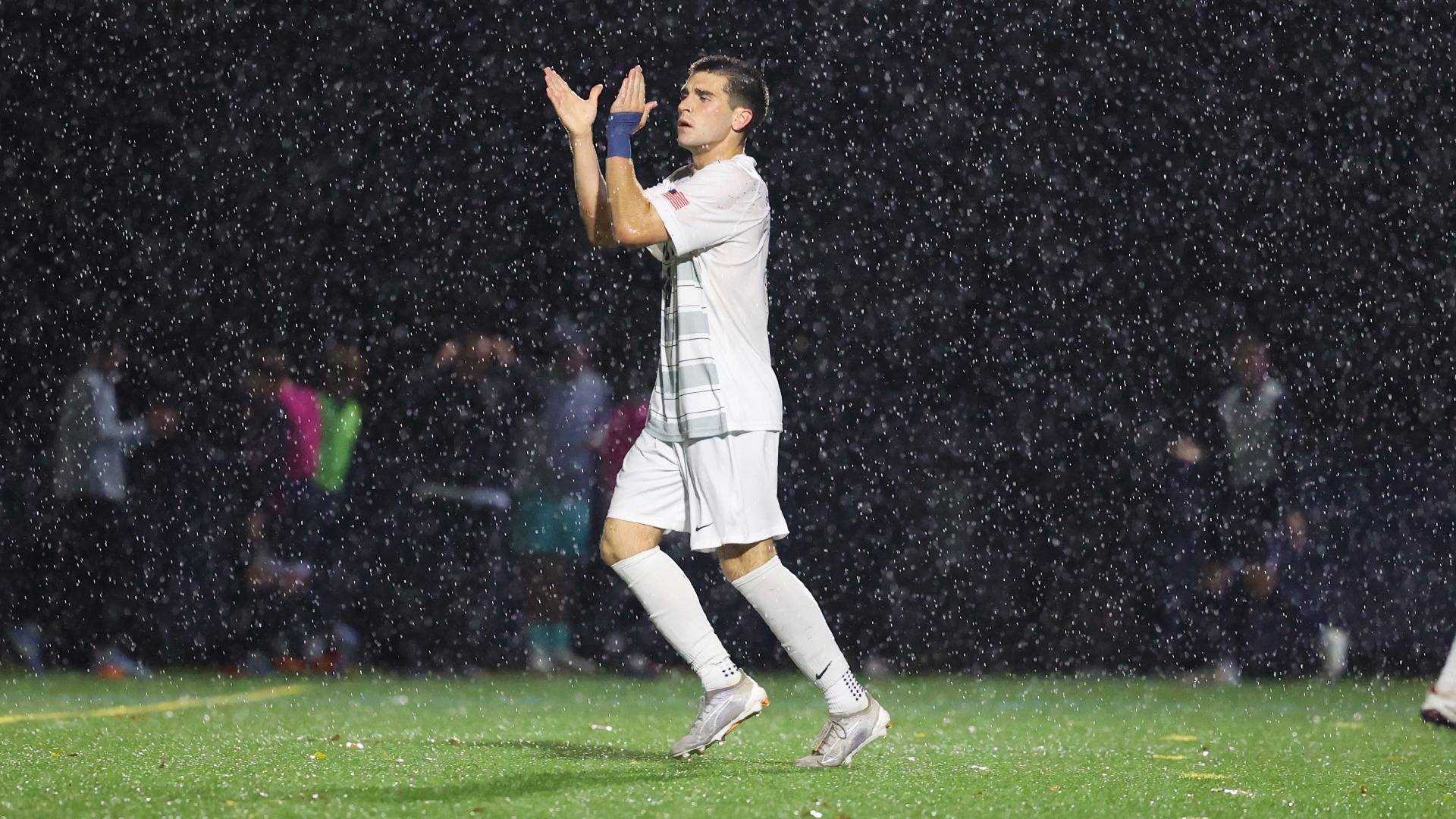 aidan mcwilliams claps in the rain during a playoff win over penn state abington in 2025