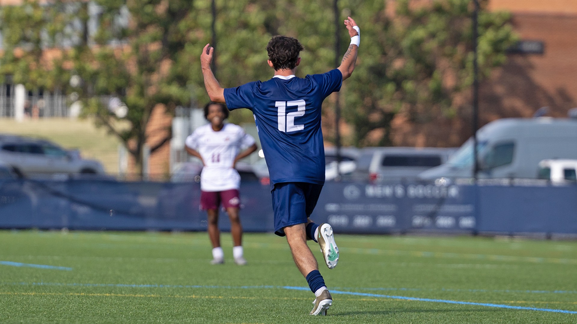 mason quinton celebrates a goal against alvernia at the multipurpose turf complex