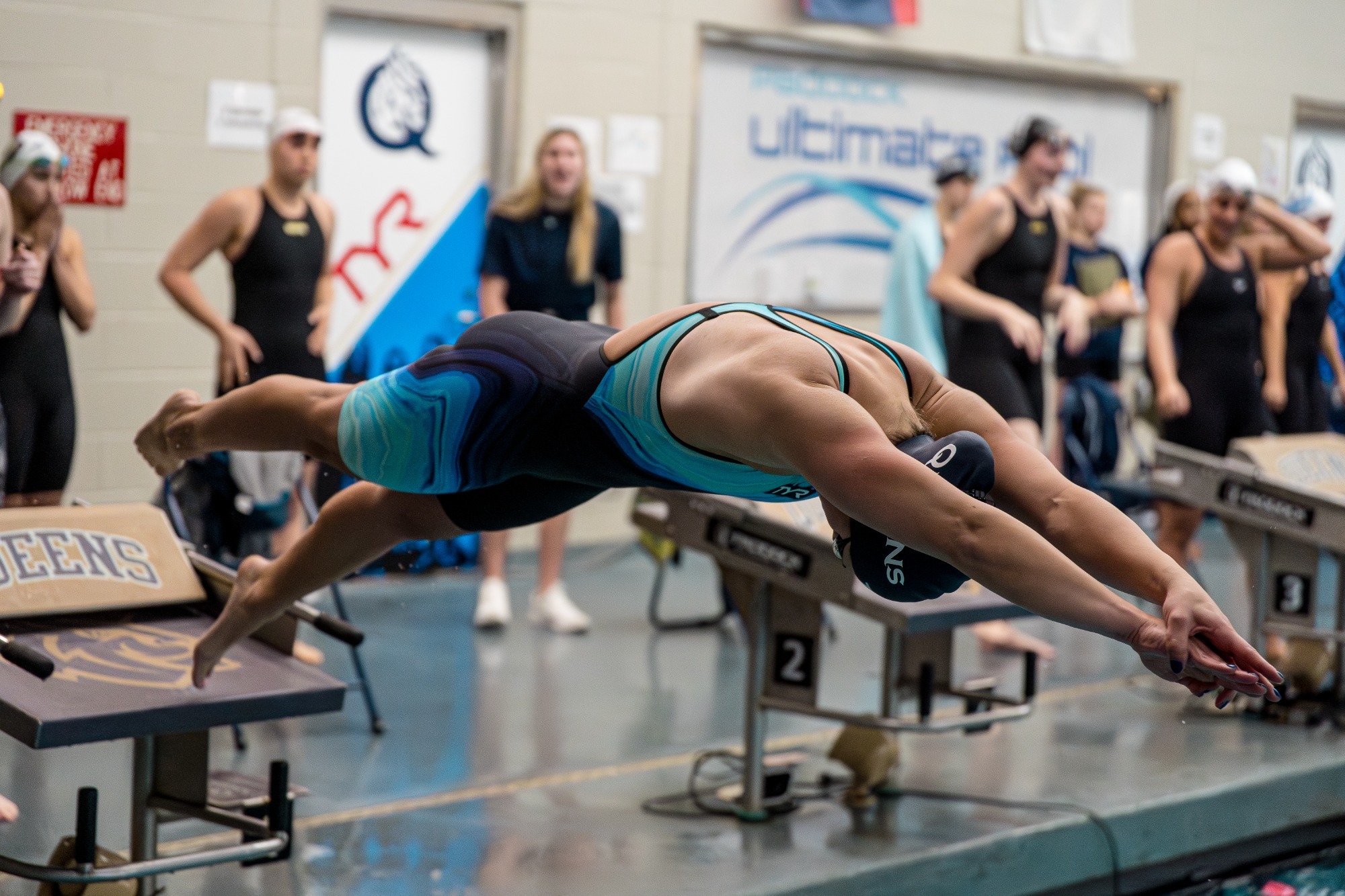 Women's Swimmer Dives into Water 