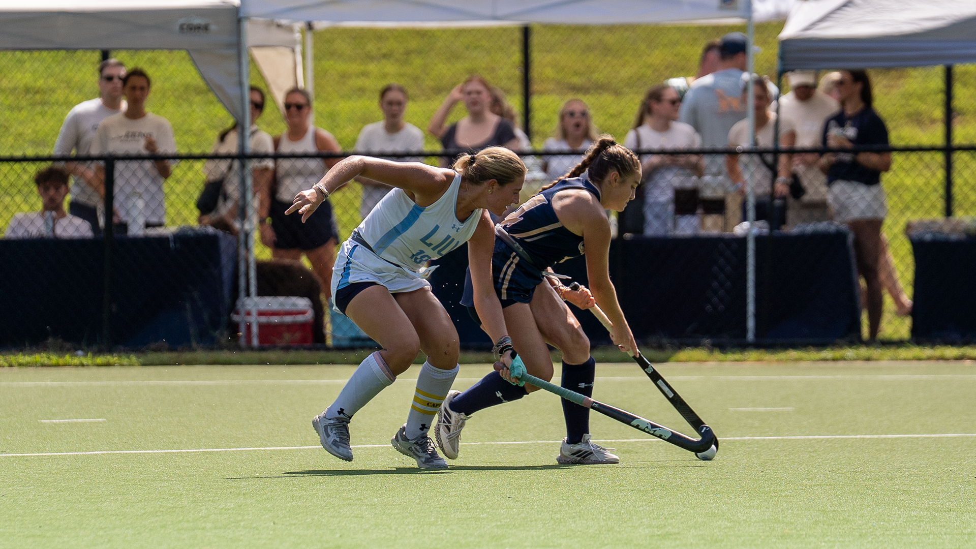 Jaxin Frazer controlling the ball against a defender.