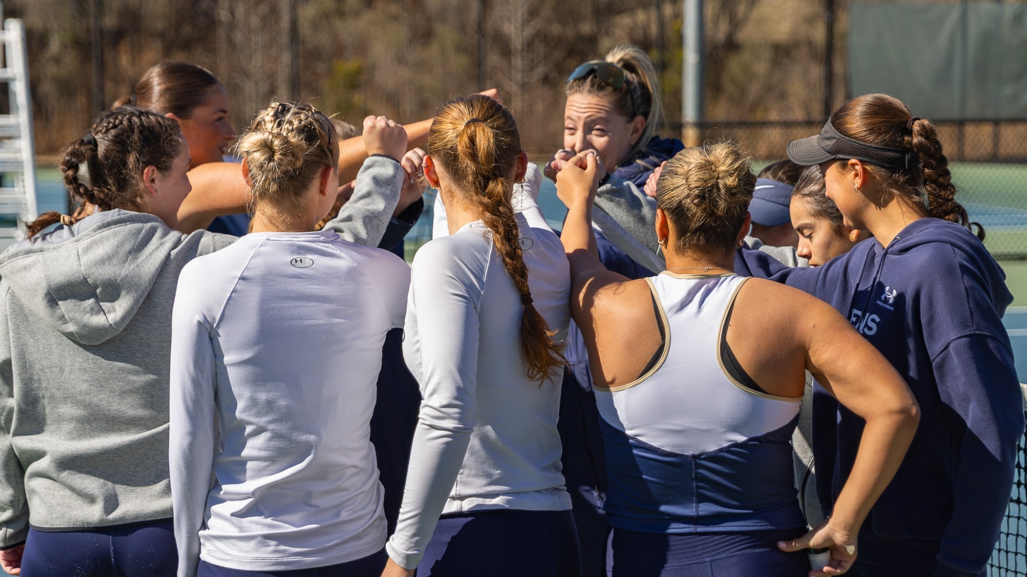 Women's tennis group huddle