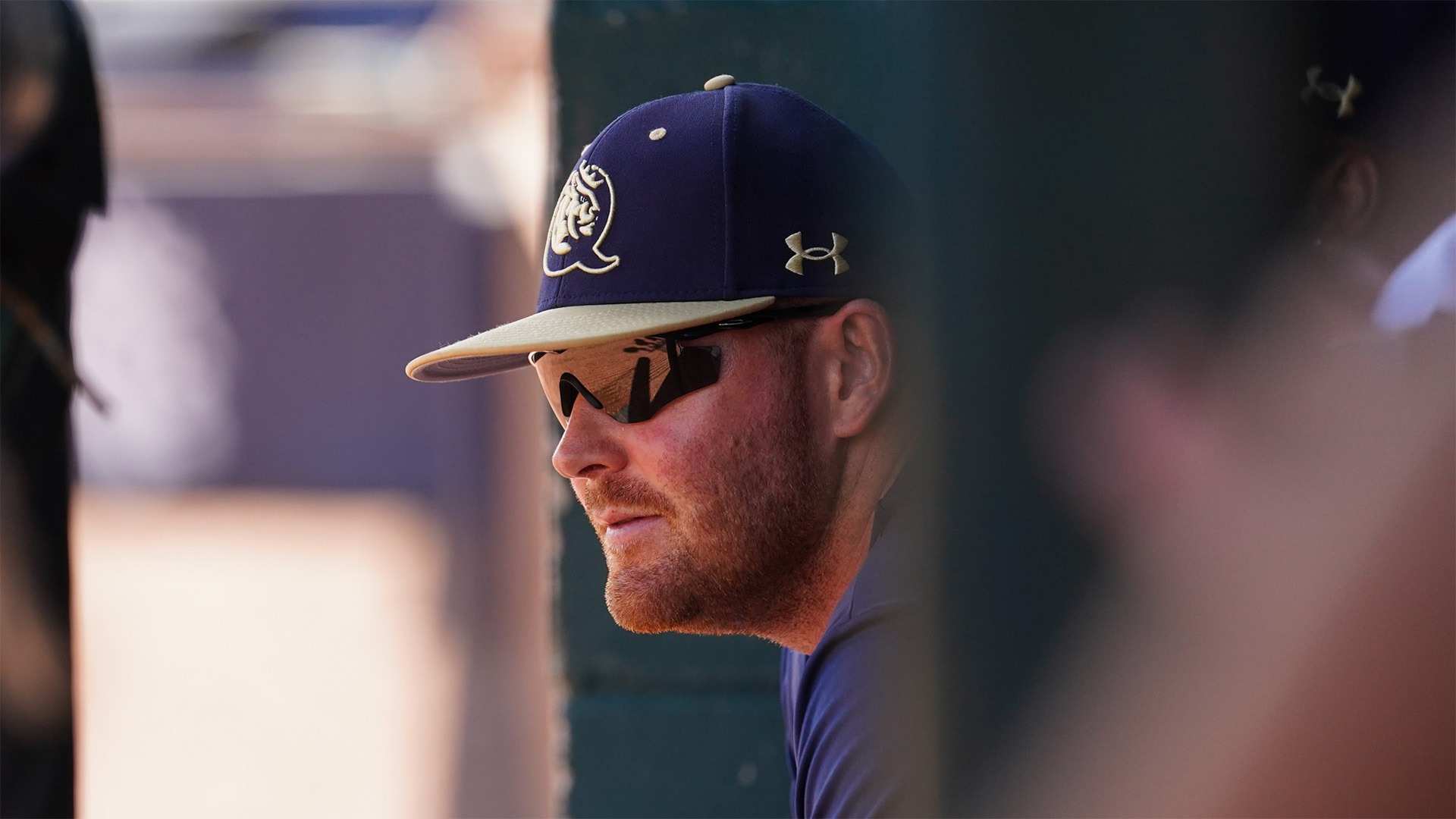 James Cullinane sitting in a chair in the dugout