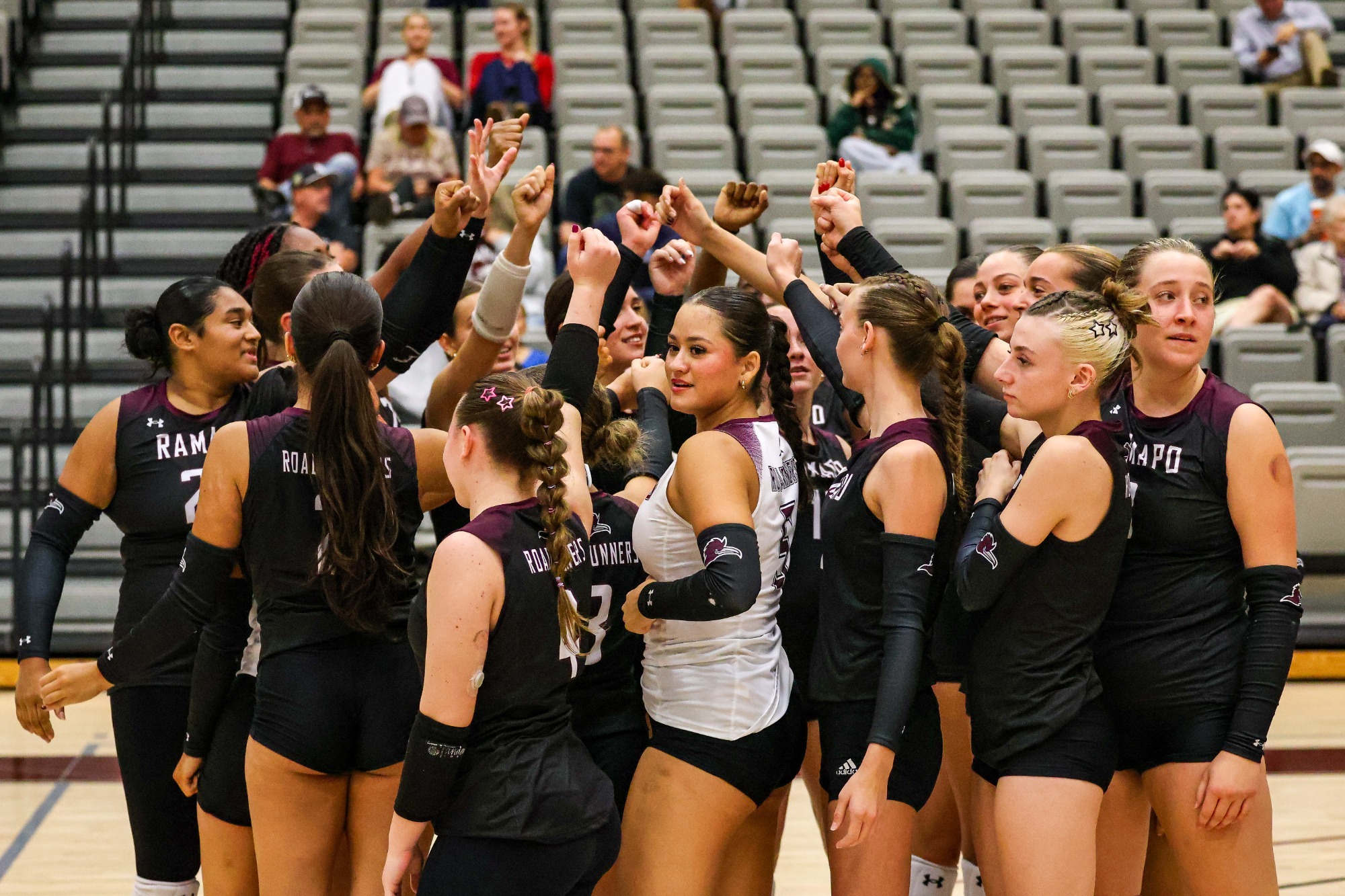 women's volleyball team huddle