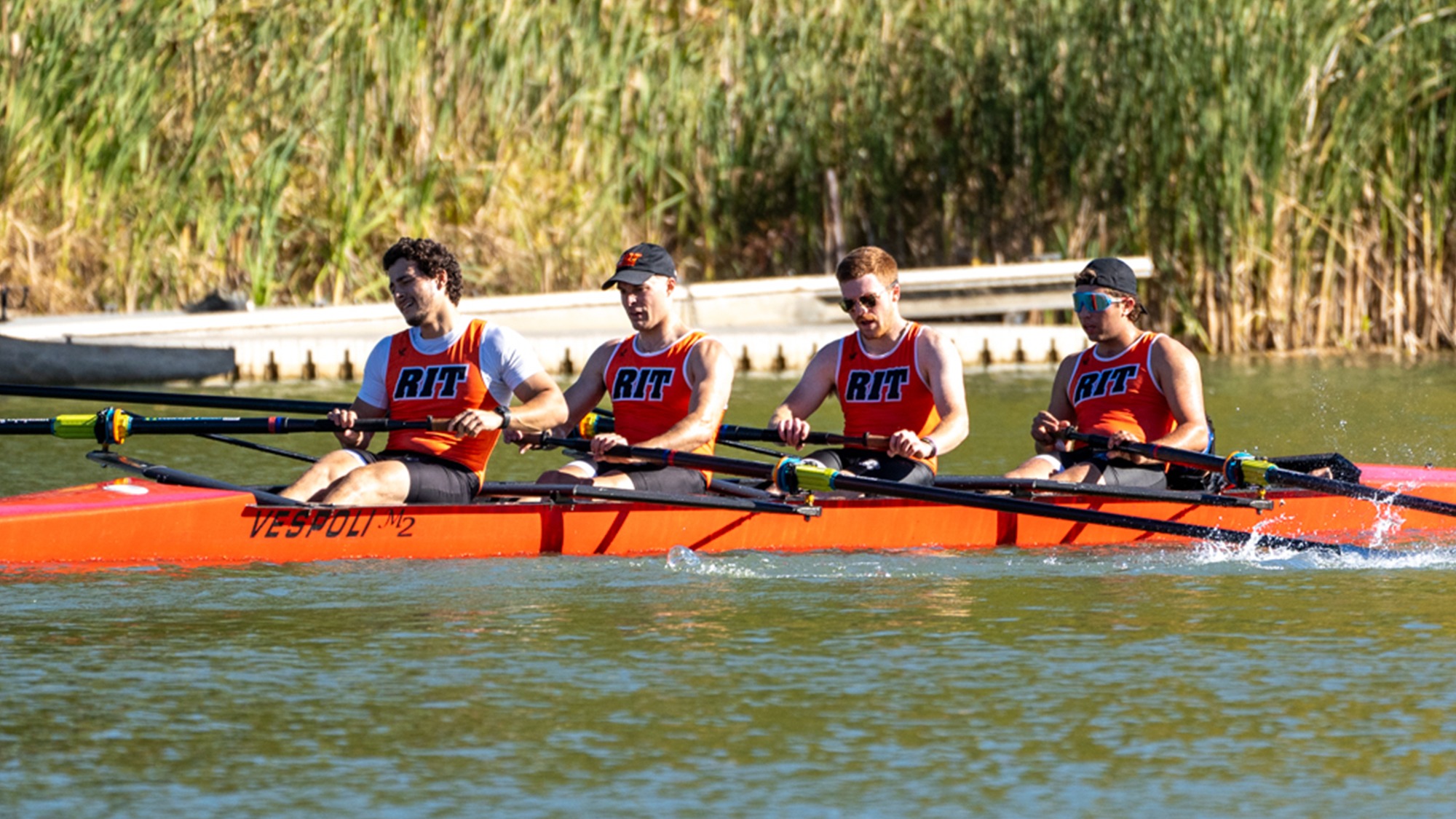 RIT men's rowing team in the water on the Genesee River
