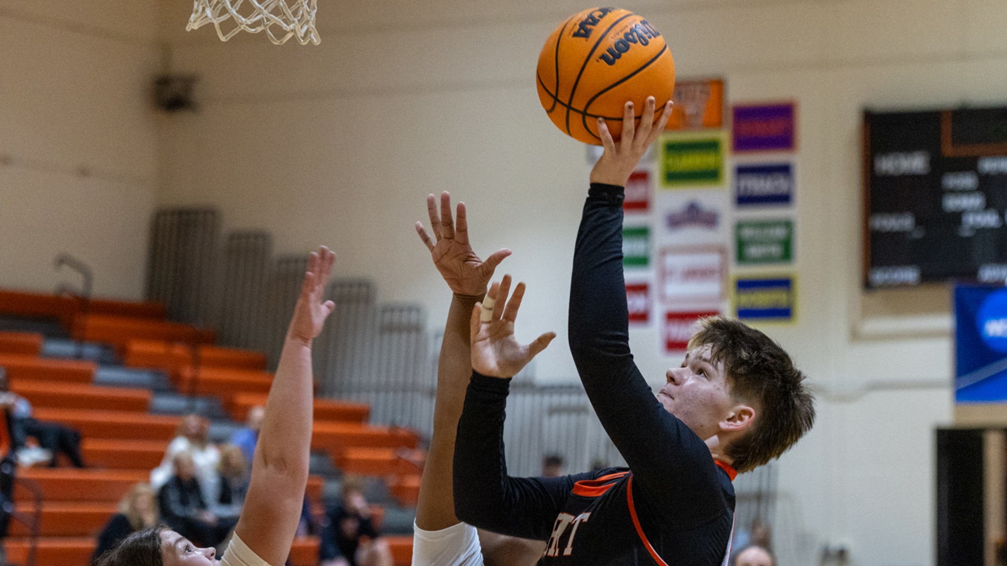 a women's basketball player for Rochester Institute of Technology makes a lay up