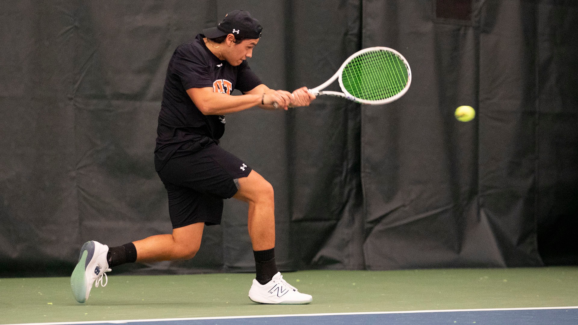 A men's tennis player hitting a forehand