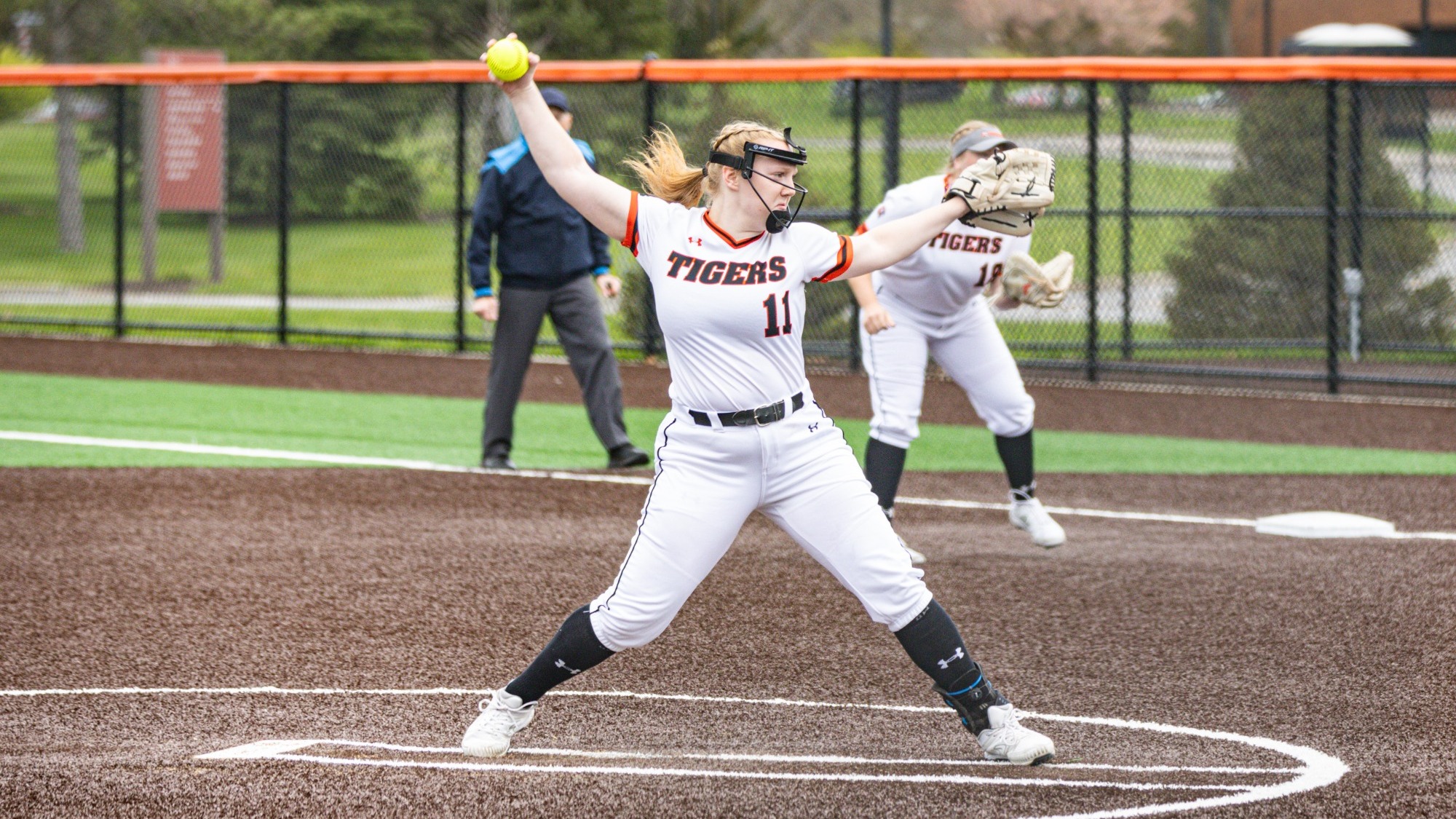 a softball pitcher throwing a pitch