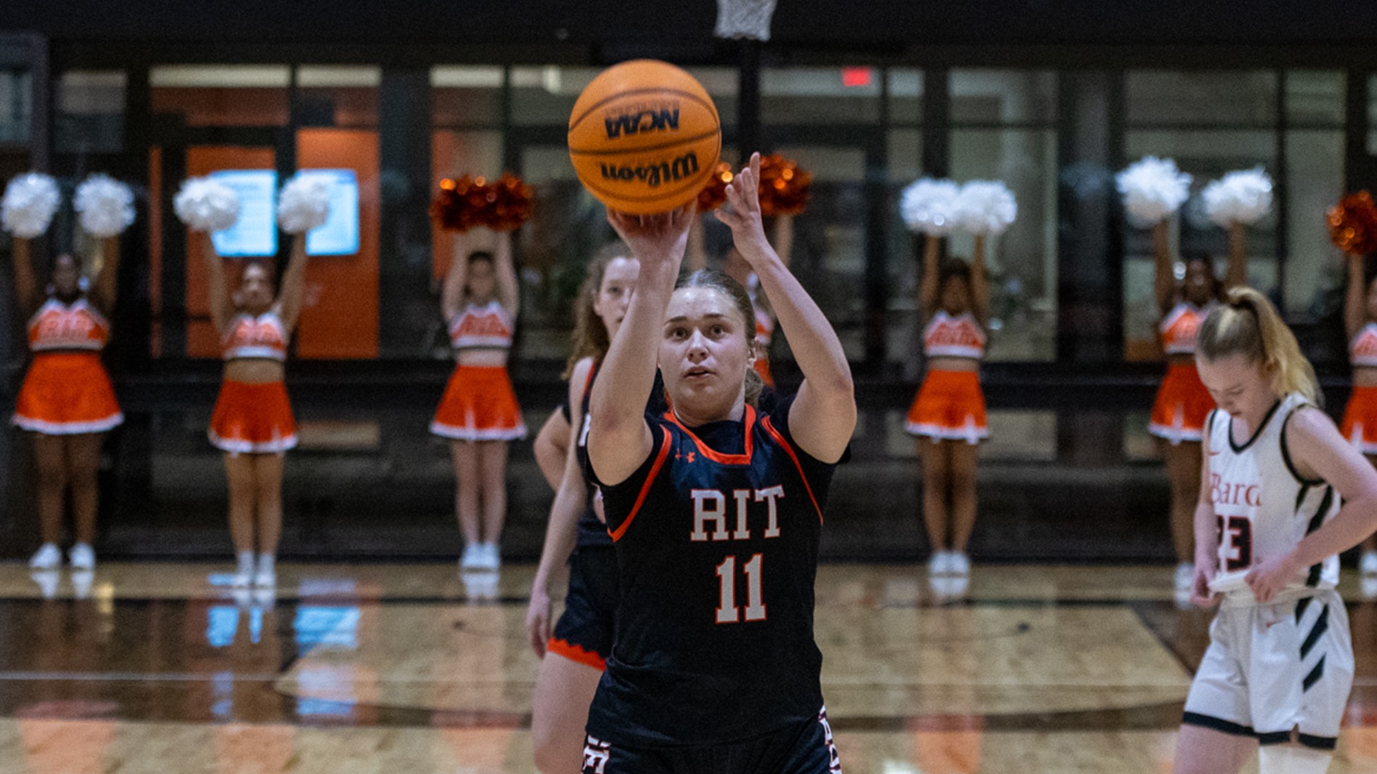 a women's basketball shoots a free throw in a game for Rochester Institute of Technology