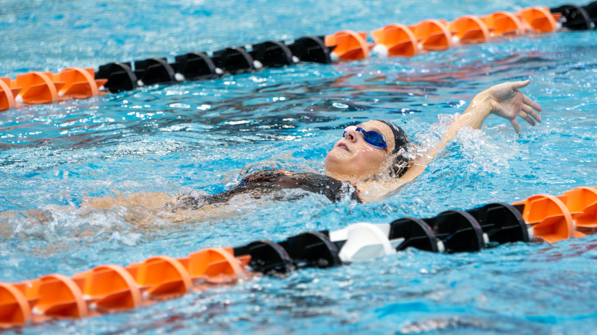 a women's swimmer competes in a backstroke event for Rochester Institute of Technology against RPI on October 11, 2025