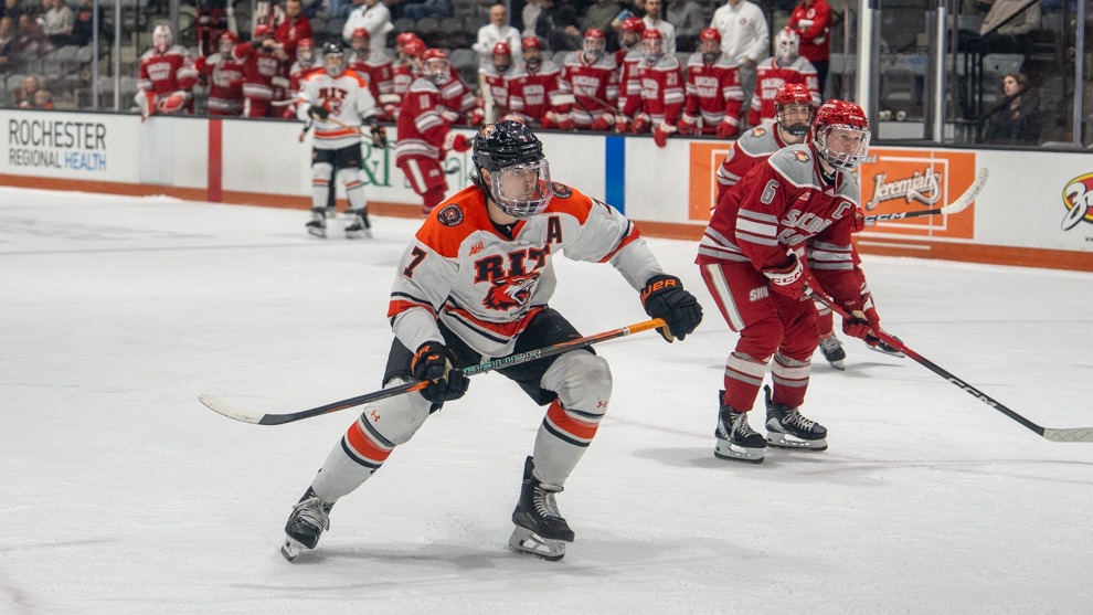 a hockey player looking forward at a play