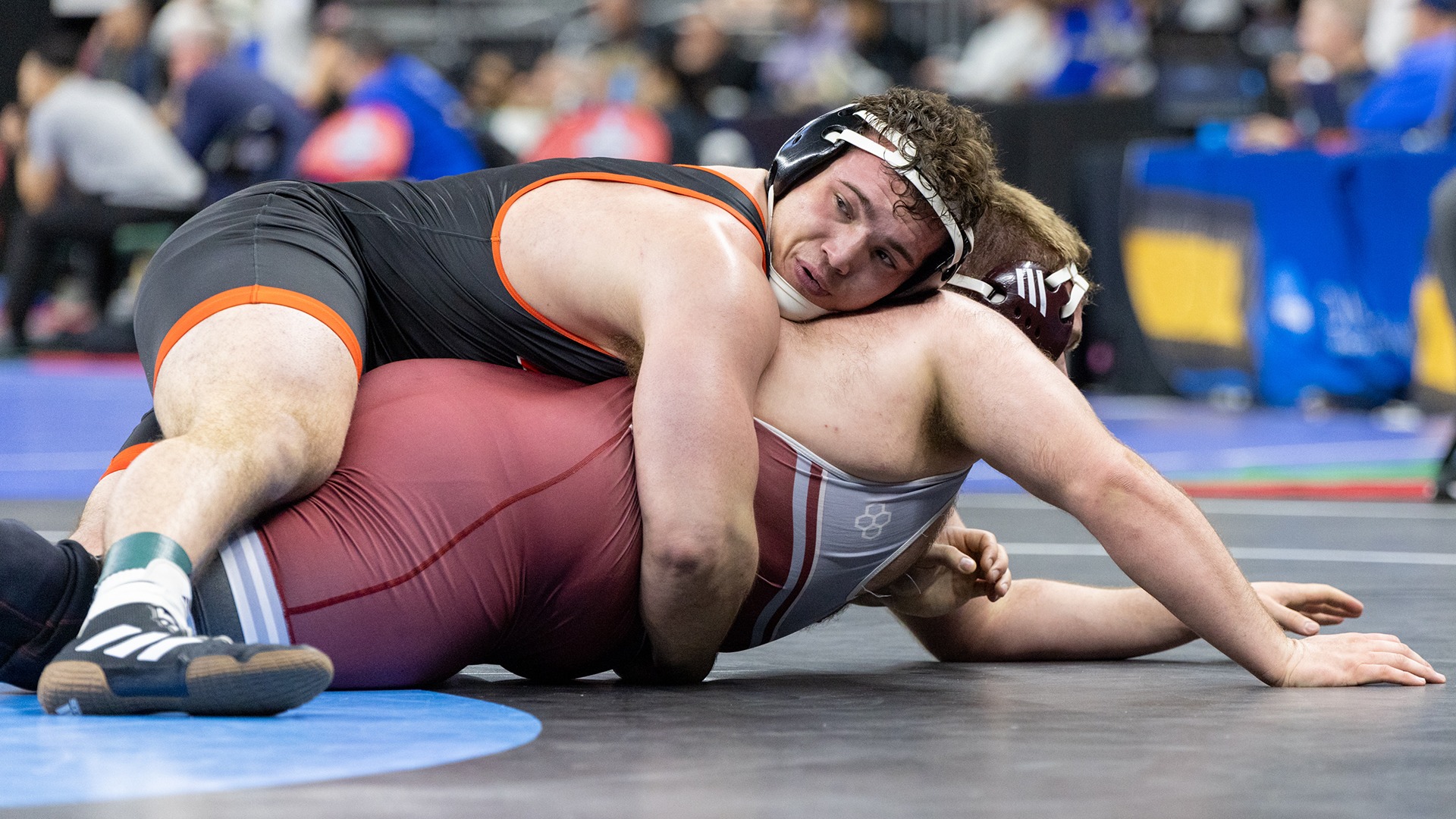 Josh Harkless holds his opponent onto the mat after a takedown