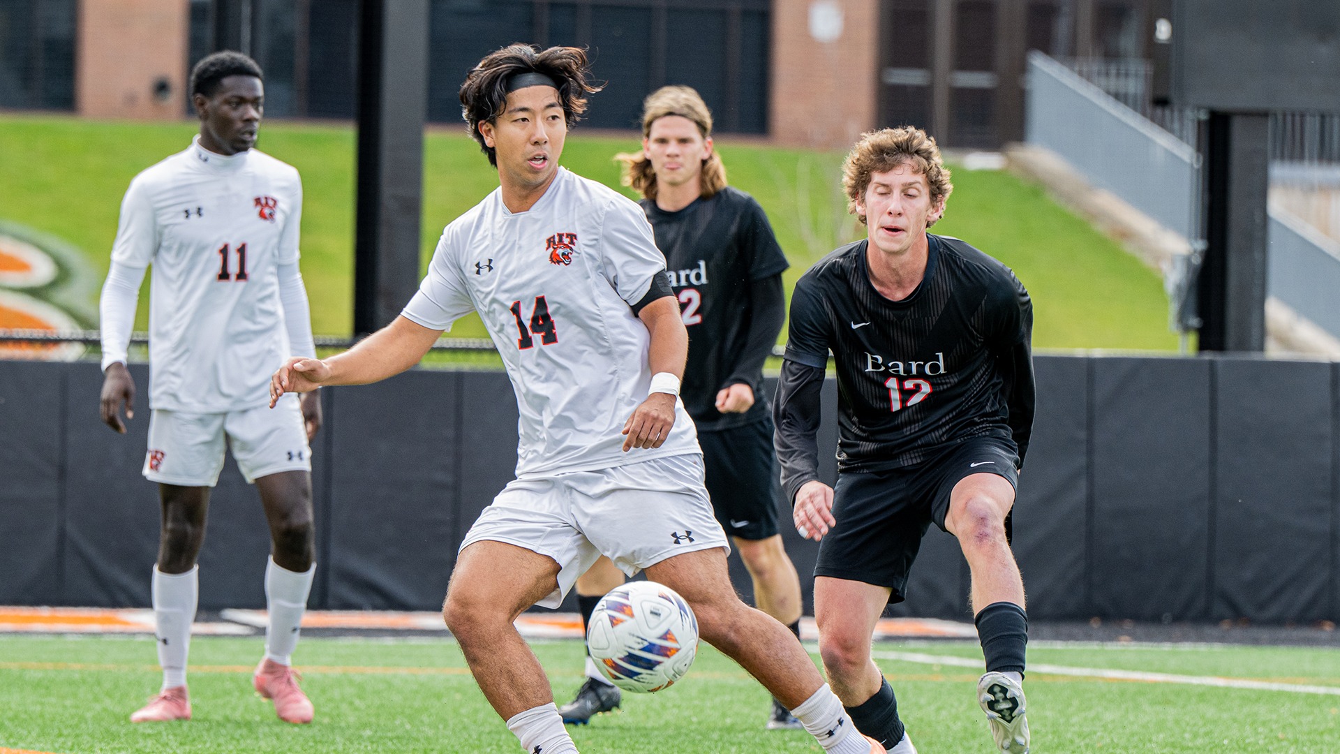Chris Lee is passing the ball to a teammate