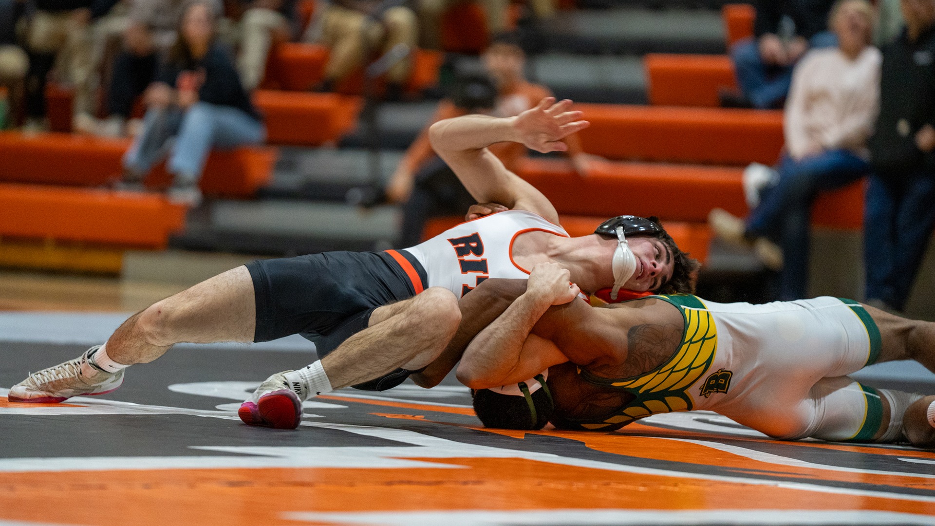 A wrestler turns to gain an advantage on his opponent