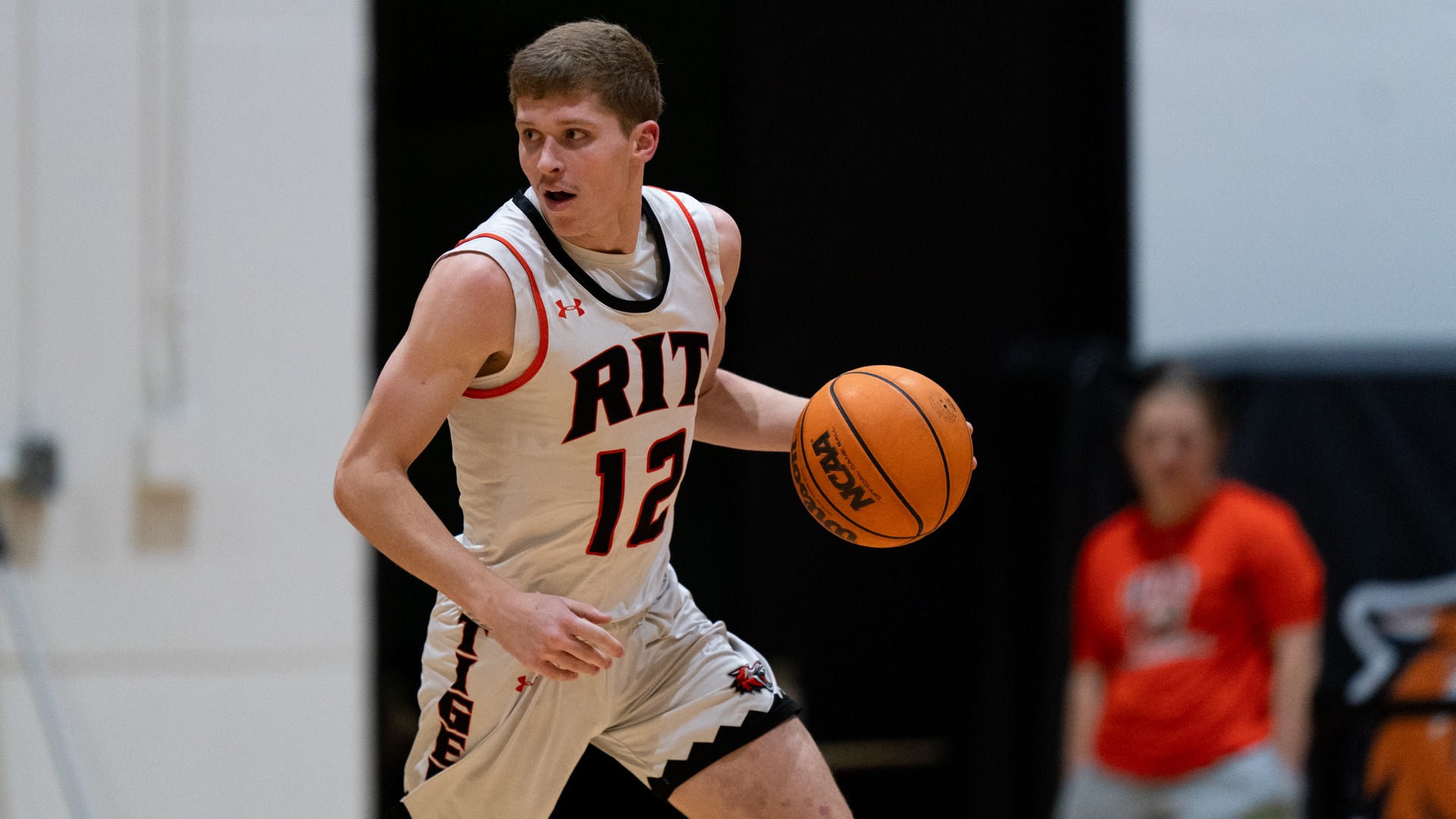 A Rochester Institute of Technology men's basketball player dribbles the ball down court in a game against Brockport on Tuesday, December 2, 2025