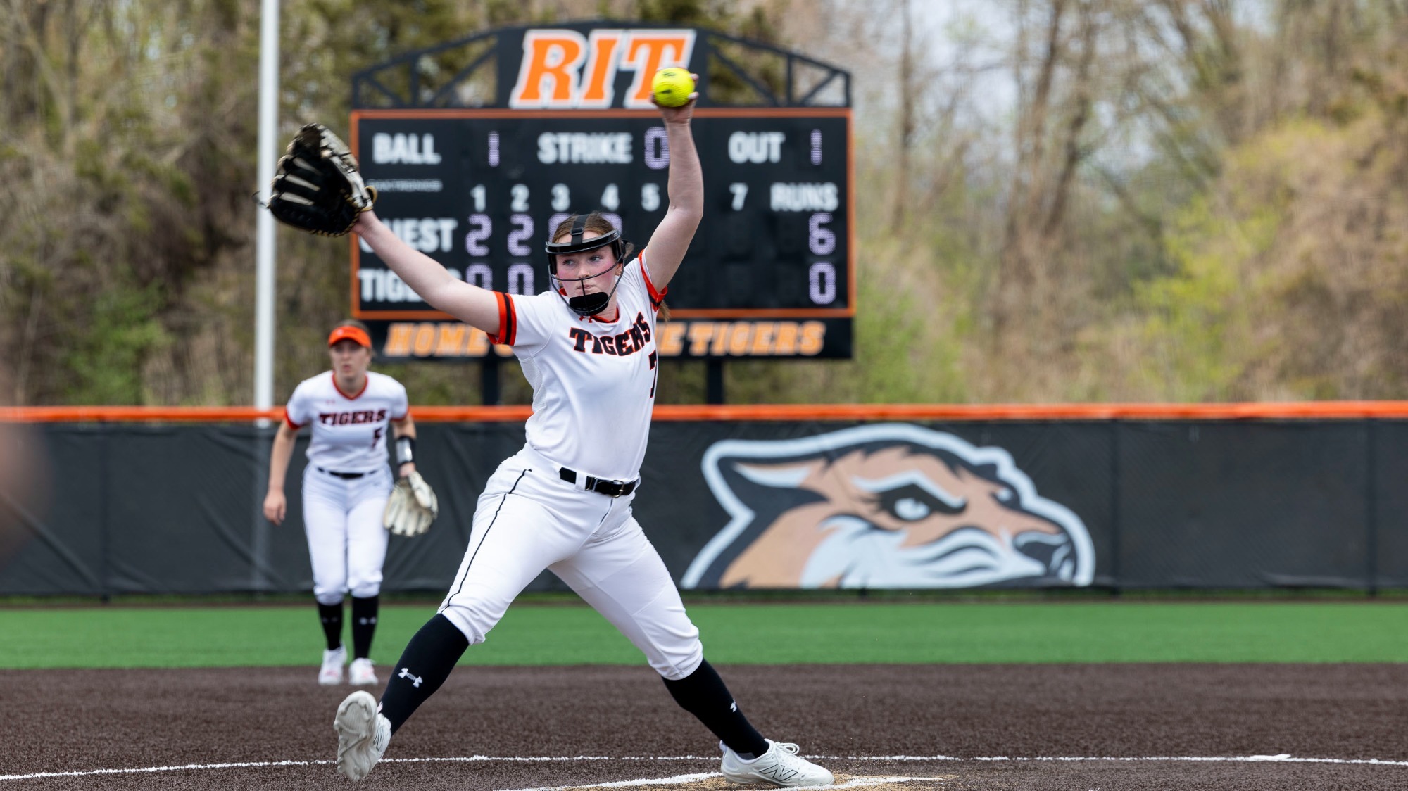 a softball pitcher throwing a pitch