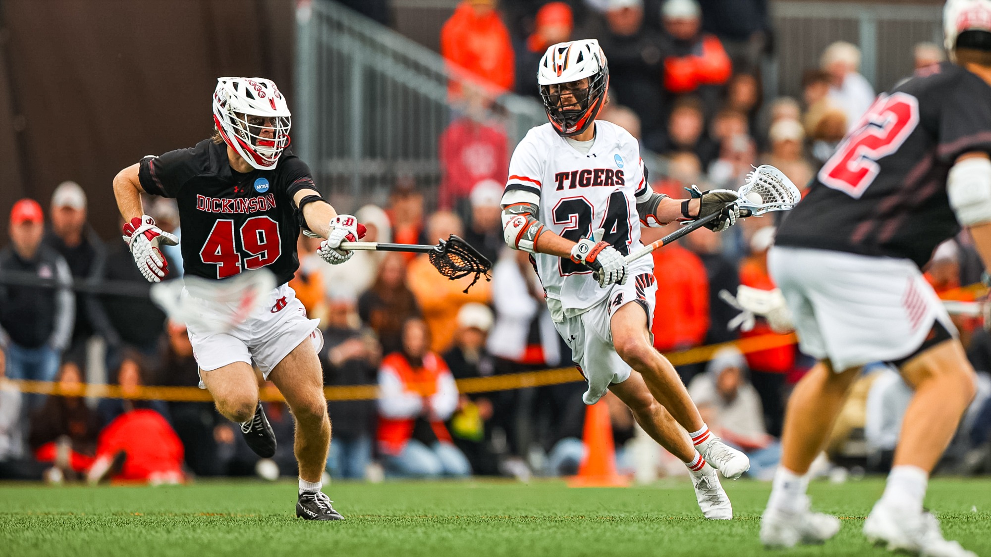 RIT's Ian Dinga, #24, runs past opposing player with the ball in game vs Cortland on Sunday, May 18, 2025, at Tiger Stadium. RIT Men's Lacrosse game vs. Dickinson. (Mikaela Engstrom/RIT Sports Network).