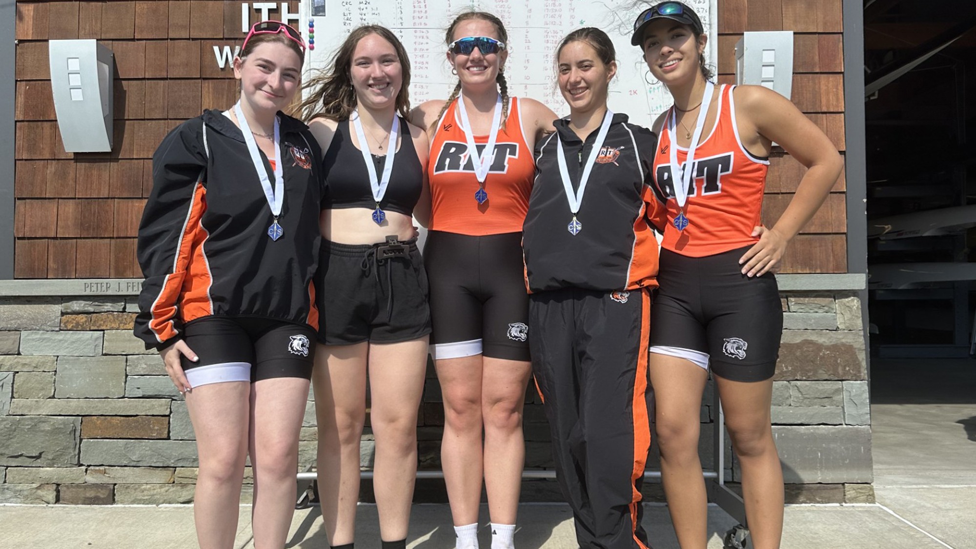 A women's rowing team from Rochester Institute of Technology celebrates winning medals at the Cayuga Sprints in Ithaca, New York