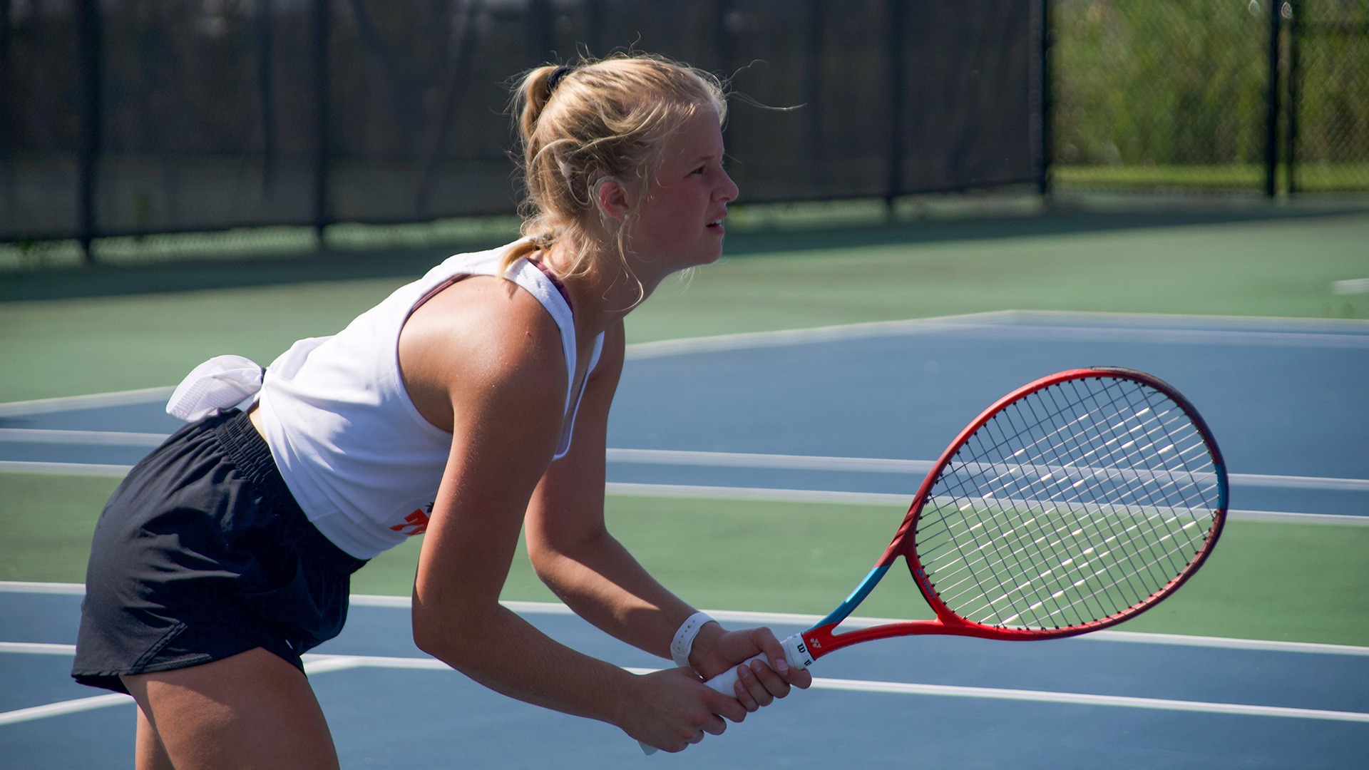 A photo of a RIT women's tennis player getting ready to receive a serve