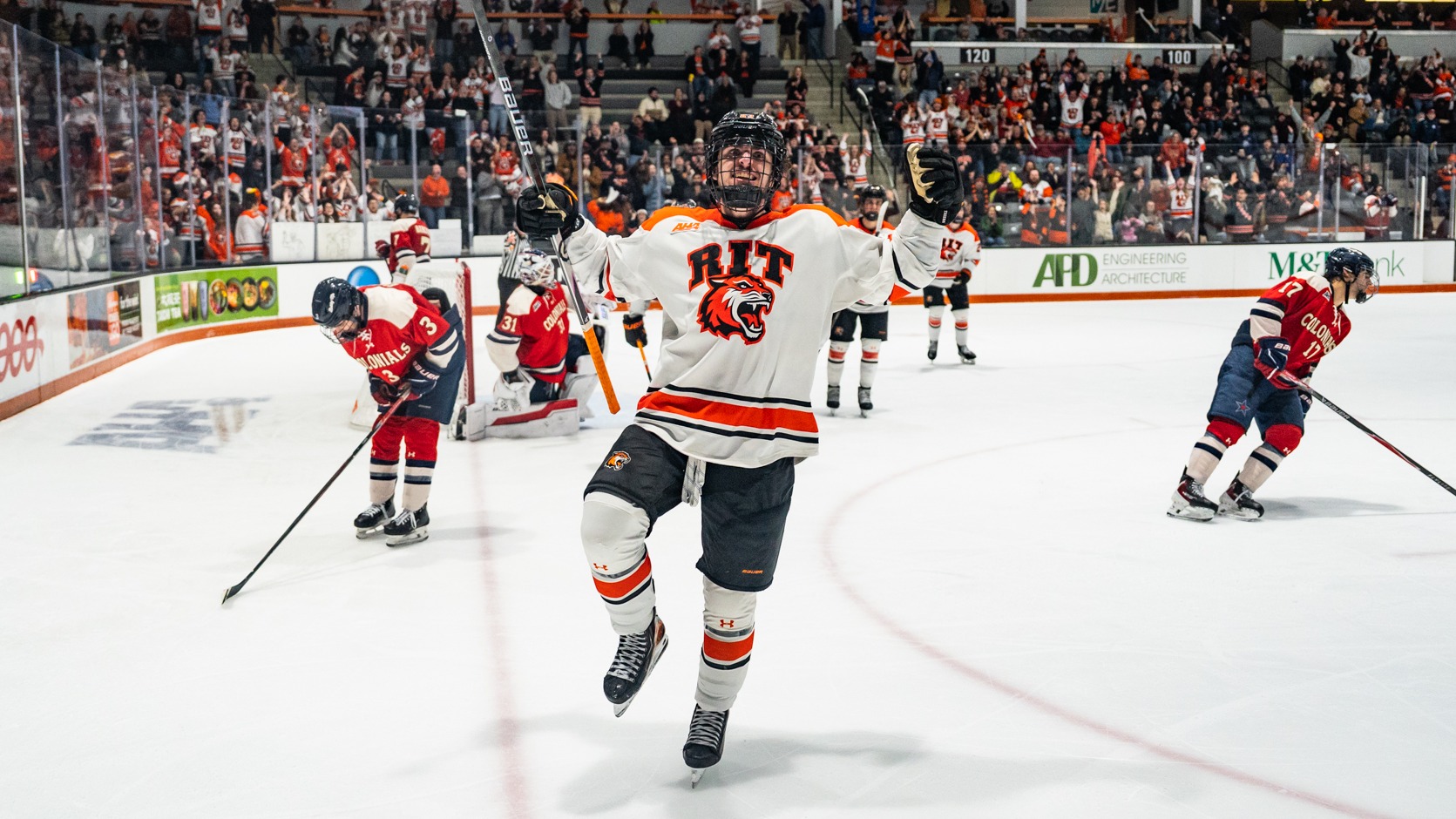 a men's hockey player celebrating a goal