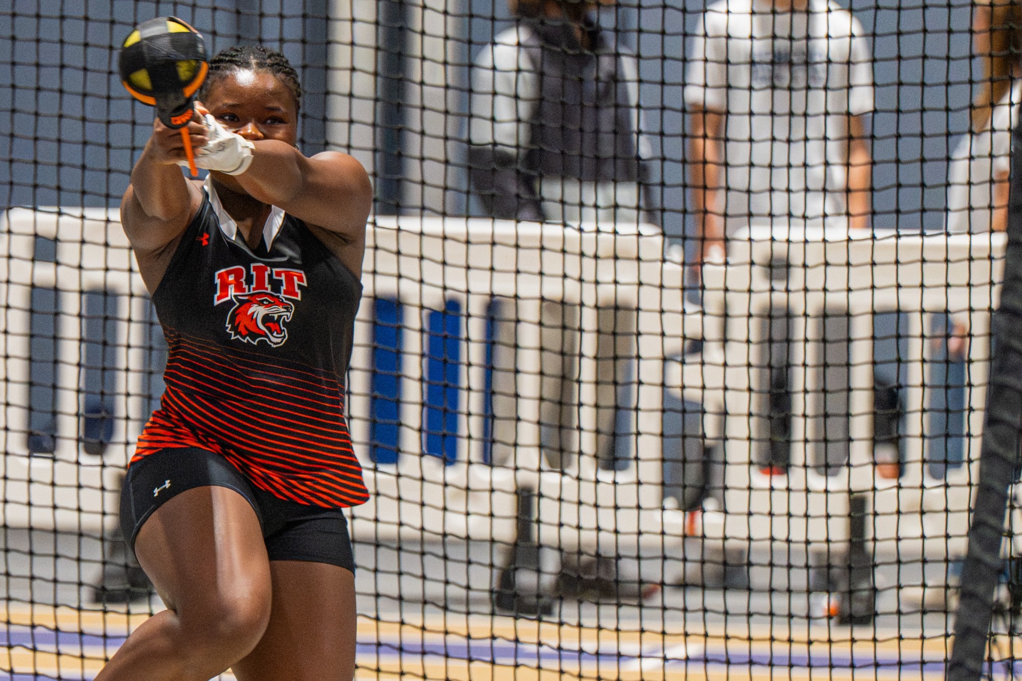 a RIT women's thrower makes an attempt in the weight throw at a meet at Nazareth University
