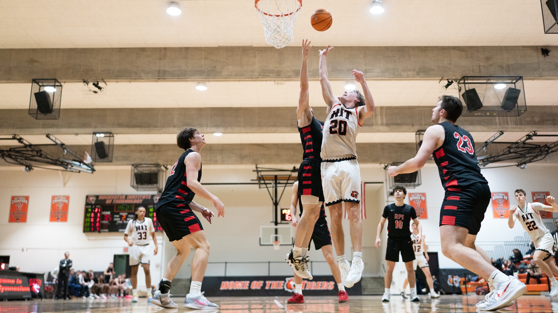 Players from both teams jump to make a rebound in a game between Rochester Institute of Technology and RPI on Saturday, January 17, 2026