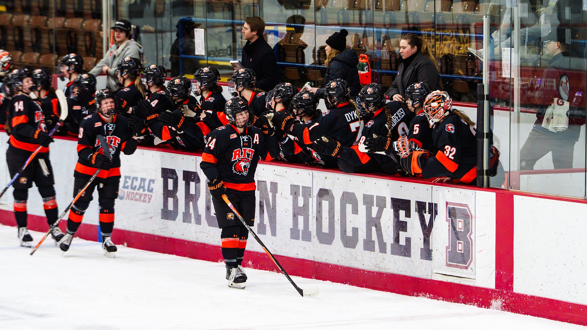 A photo of Linda Rulle leading RIT through handshakes after scoring a goal at Brown Jan. 24
