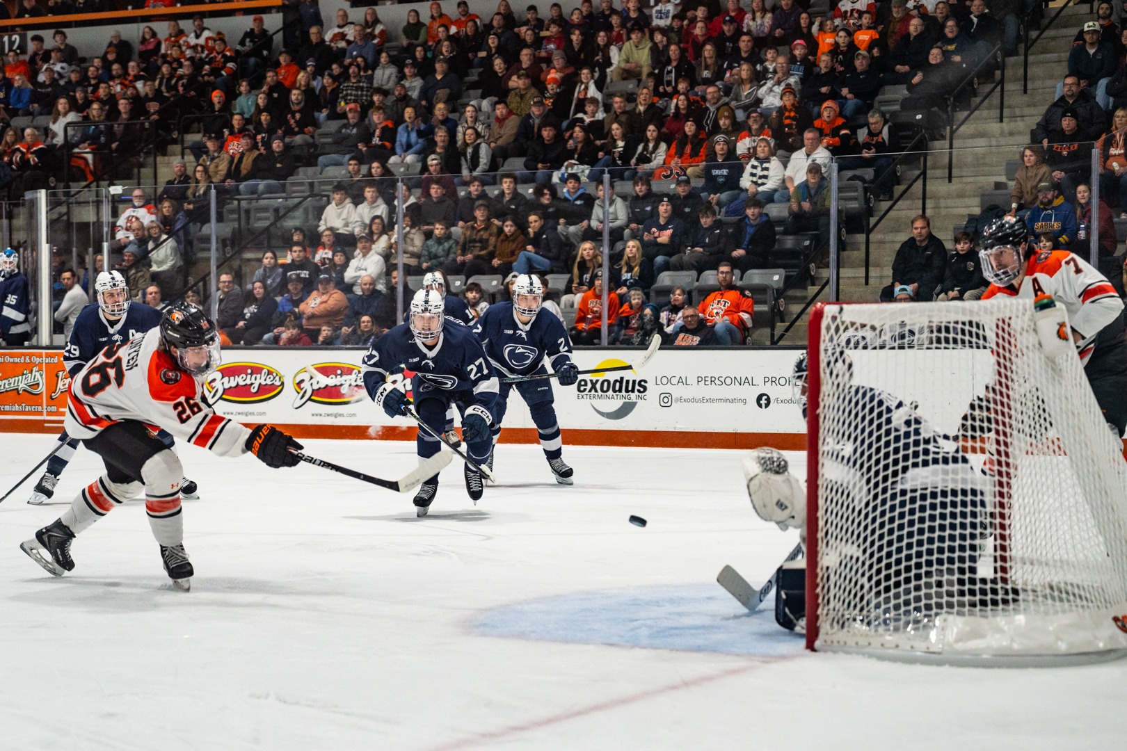 a men's hockey play shooting on goal