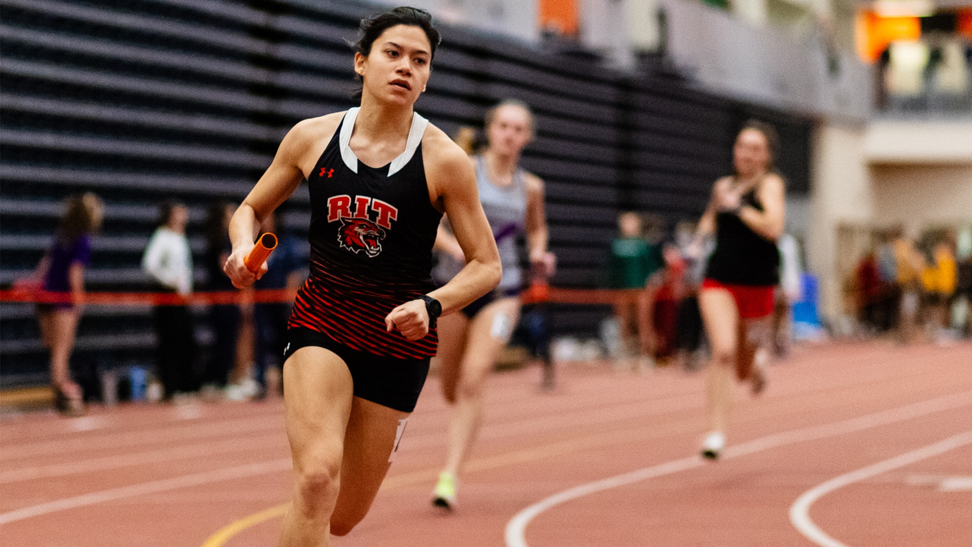 RIT Track and Field athlete runs by in relay on Jan. 24, 2026, at Gordon Field House in Rochester, N.Y. RIT’s Track and Field competes at RIT Friday Invitational. RIT Men’s and Women’s Track and Field.